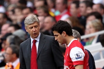 LONDON, ENGLAND - APRIL 02:  Arsenal manager Arsene Wenger talks to Cesc Fabregas of Arsenal as he prepares to go on during the Barclays Premier League match between Arsenal and Blackburn Rovers at the Emirates Stadium on April 2, 2011 in London, England.