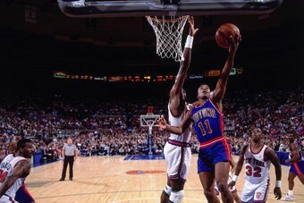 NEW YORK - 1991:  Isiah Thomas #11 of the Detroit Pistons shoots a layup against Patrick Ewing #33 of the New York Knicks during a game in 1991 at Madison Square Garden in New York, New York. NOTE TO USER: User expressly acknowledges that, by downloading 