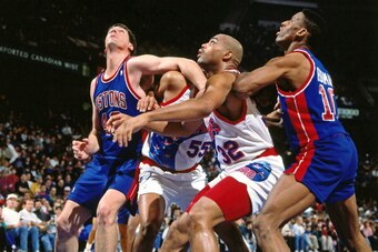PHILADELPHIA - CIRCA 1991: Bill Laimbeer #40 of the Detroit Pistons boxes out against Charles Barkley #32 of the Philadelphia 76ers circa 1991 at the Spectrum in Philadelphia, Pennsylvania. NOTE TO USER: User expressly acknowledges and agrees that, by dow