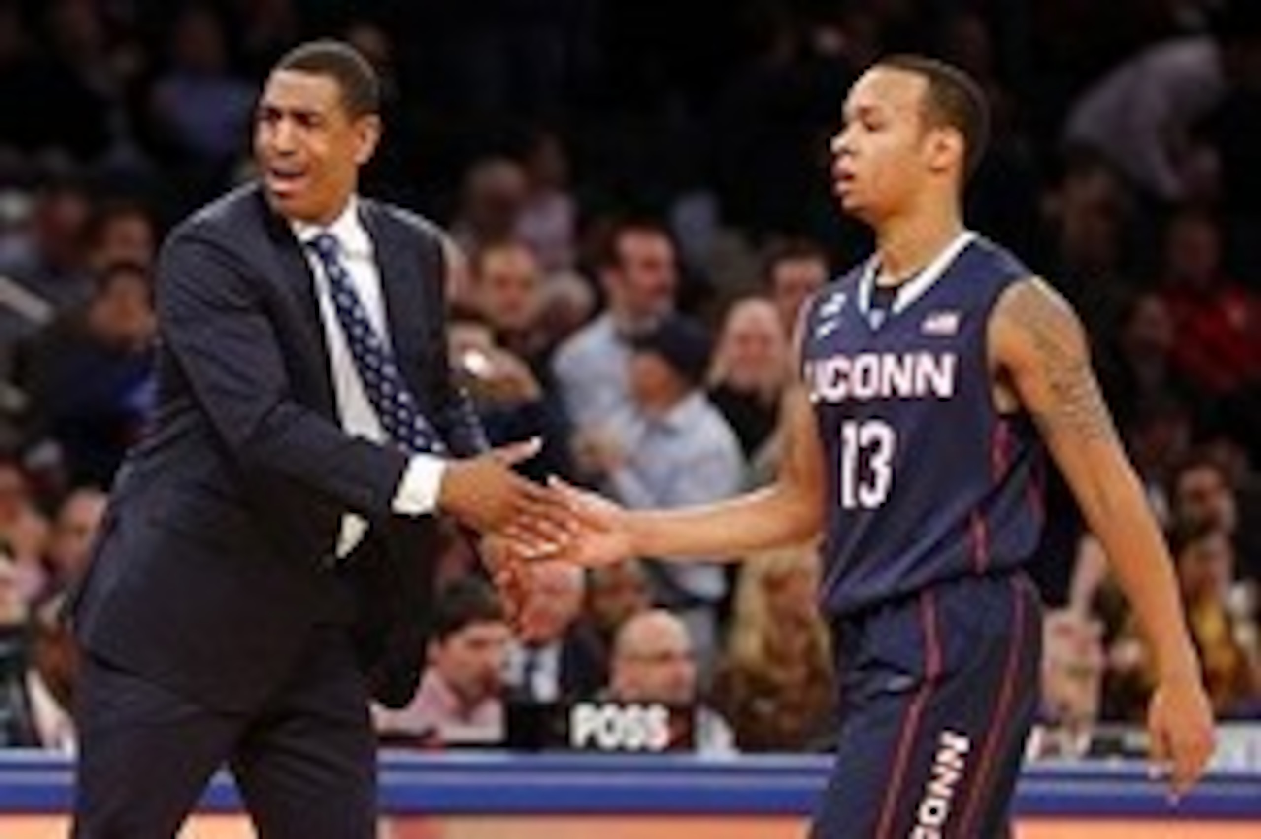 Nov 21, 2013; New York, NY, USA;  Connecticut Huskies head coach Kevin Ollie congratulates guard Shabazz Napier (13) as they hold off Boston College Eagles at Madison Square Garden. Connecticut Huskies defeat the Boston College Eagles 72-70. Mandatory Cre