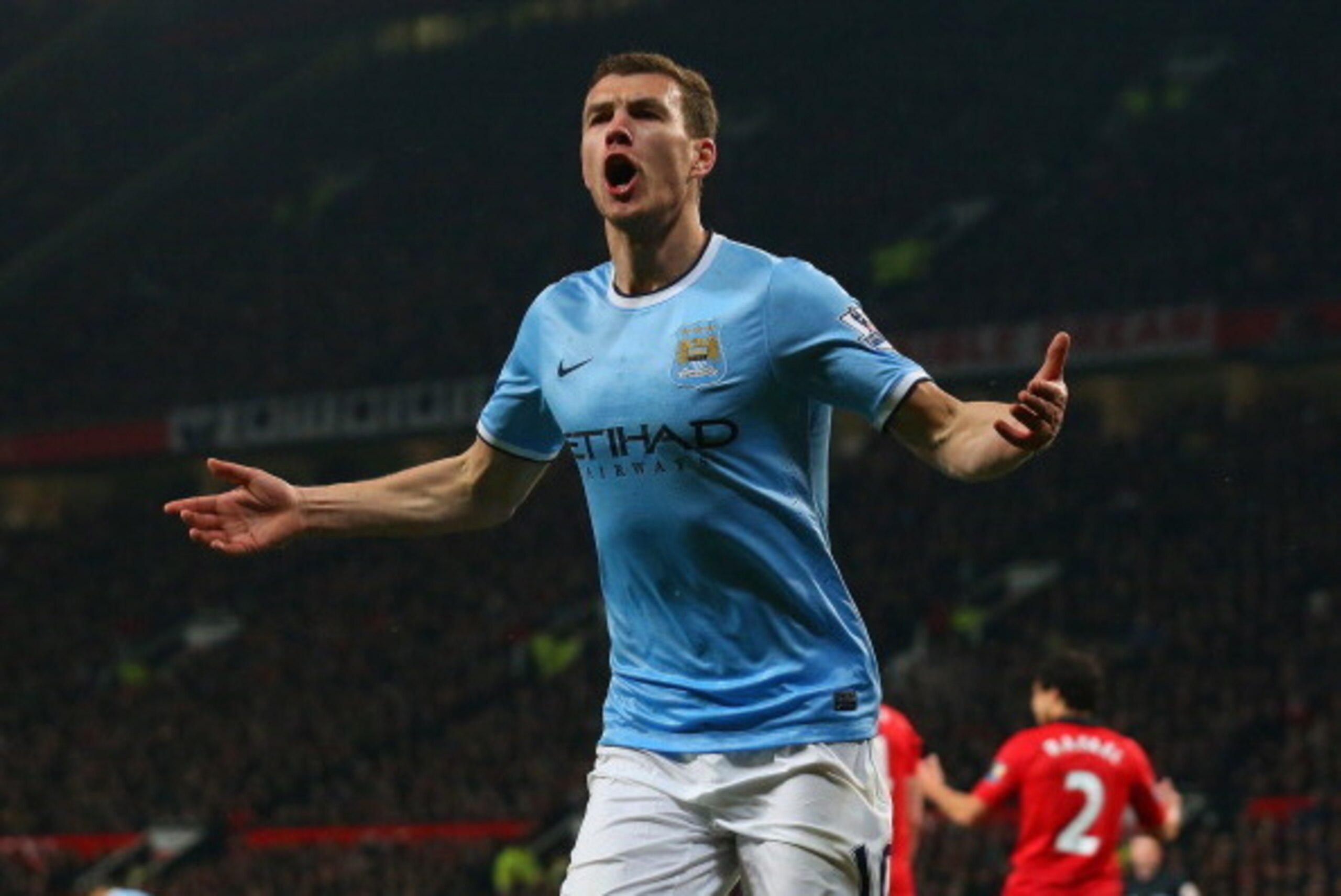 MANCHESTER, ENGLAND - MARCH 25:  Edin Dzeko of Manchester City celebrates scoring the second goal during the Barclays Premier League match between Manchester United and Manchester City at Old Trafford on March 25, 2014 in Manchester, England.  (Photo by A