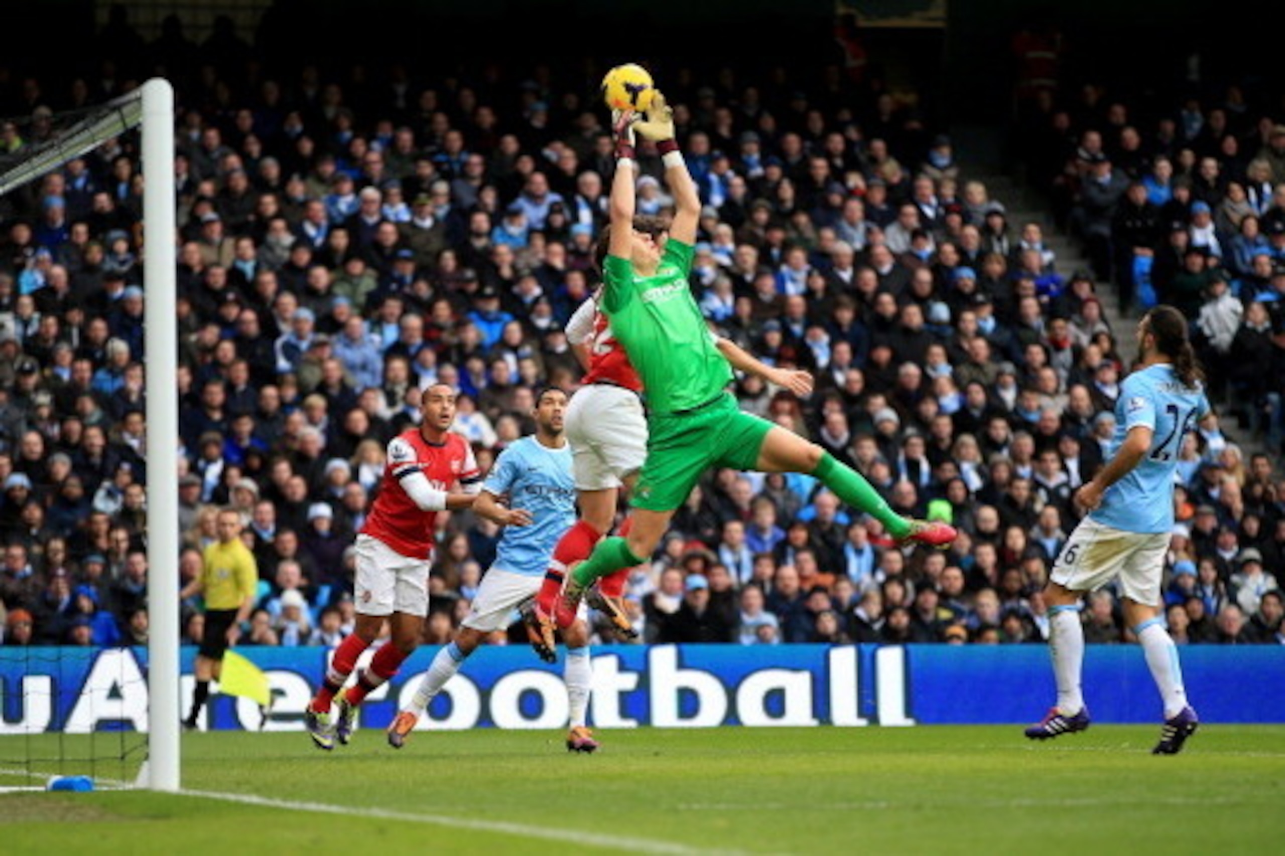 MANCHESTER, ENGLAND - DECEMBER 14:  Costel Pantilimon of Manchester City fails to hold onto a cross during the Barclays Premier League match between Manchester City and Arsenal at Etihad Stadium on December 14, 2013 in Manchester, England.  (Photo by Rich