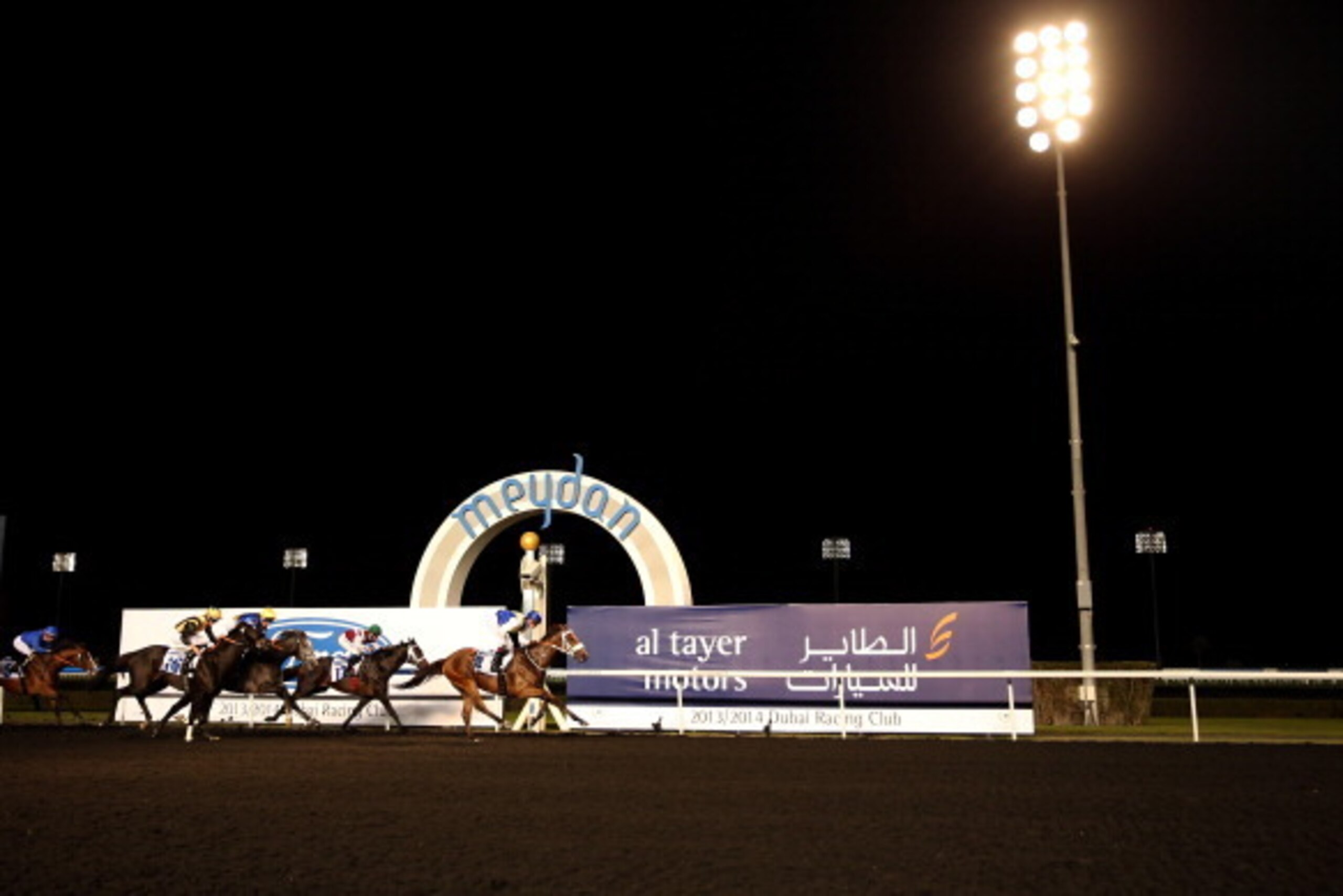 DUBAI, UNITED ARAB EMIRATES - FEBRUARY 13:  Sanshaawes ridden by Christophe Soumillon (blue and yellos silks) wins the Ford F-150 Raptor Trophy during the Dubai World Cup Carnival Races at the Meydan Racecourse on February 13, 2014 in Dubai, United Arab E