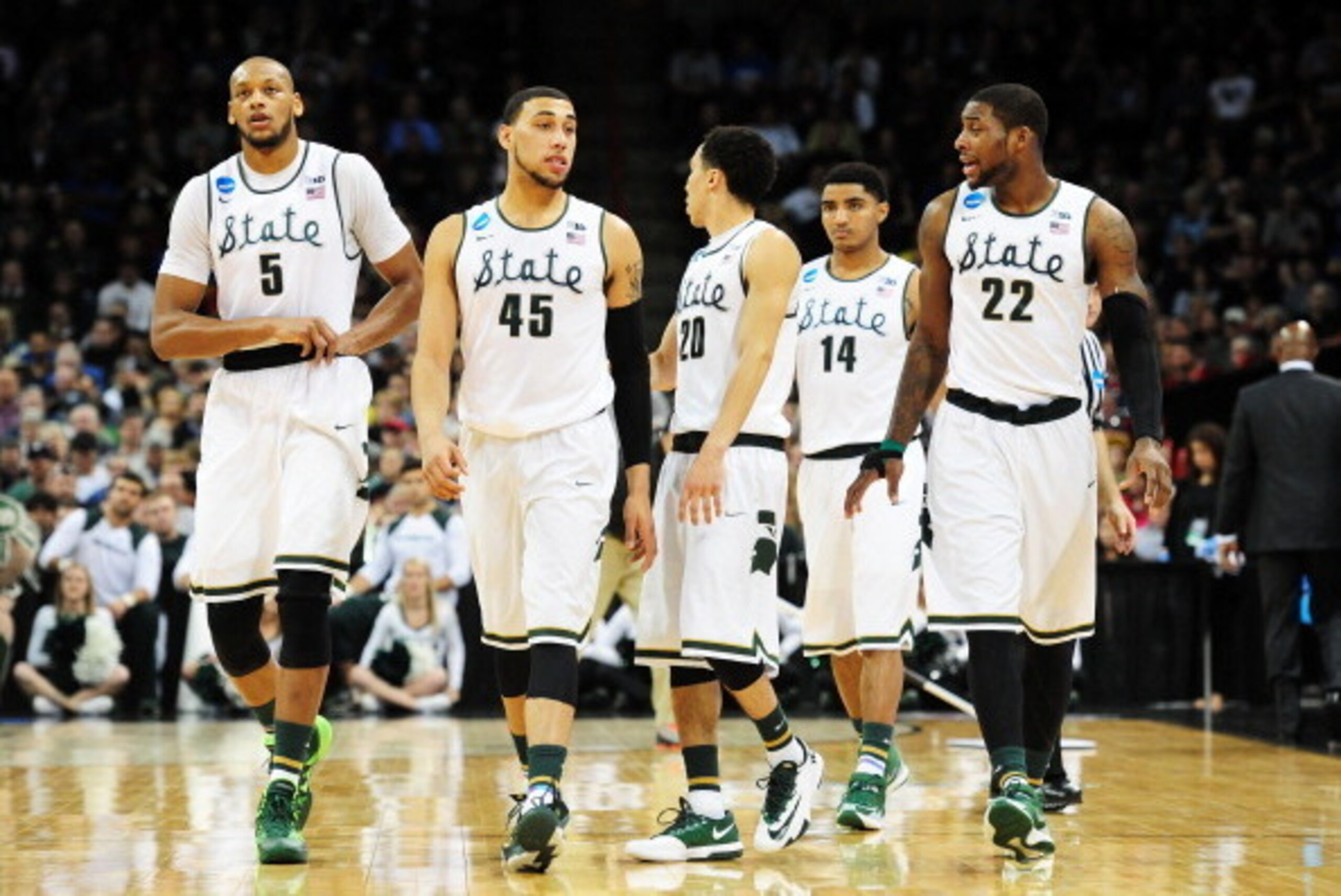 SPOKANE, WA - MARCH 22:  Adreian Payne #5 Denzel Valentine #45 Travis Trice #20 Gary Harris #14 and Branden Dawson #22 of the Michigan State Spartans look on against the Harvard Crimson in the second half during the Third Round of the 2014 NCAA Basketball