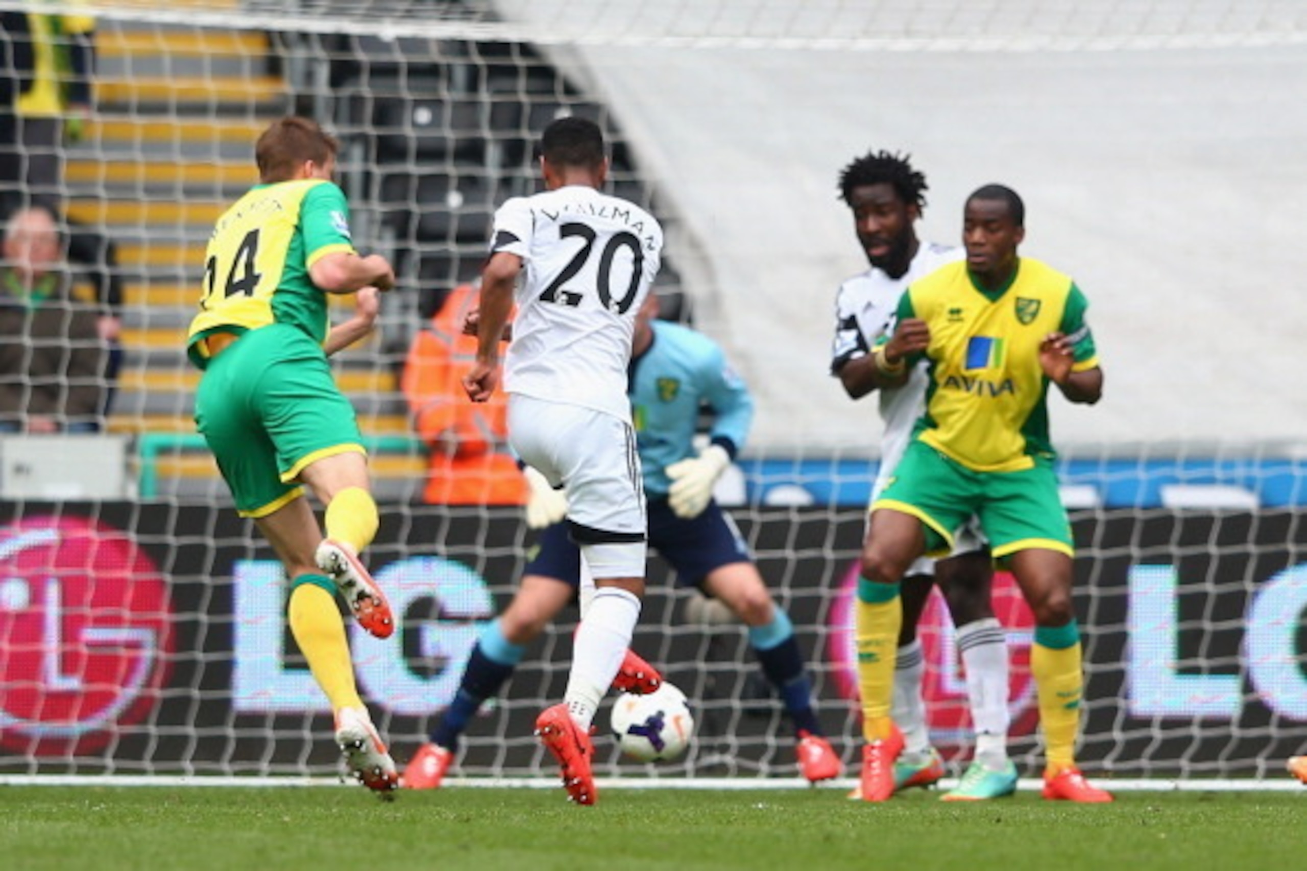 SWANSEA, WALES - MARCH 29:  Jonathan de Guzman (#20) of Swansea City scores the opening goal during the Barclays Premier League match between Swansea City and Norwich City at the Liberty Stadium on March 29, 2014 in Swansea, Wales.  (Photo by Michael Stee
