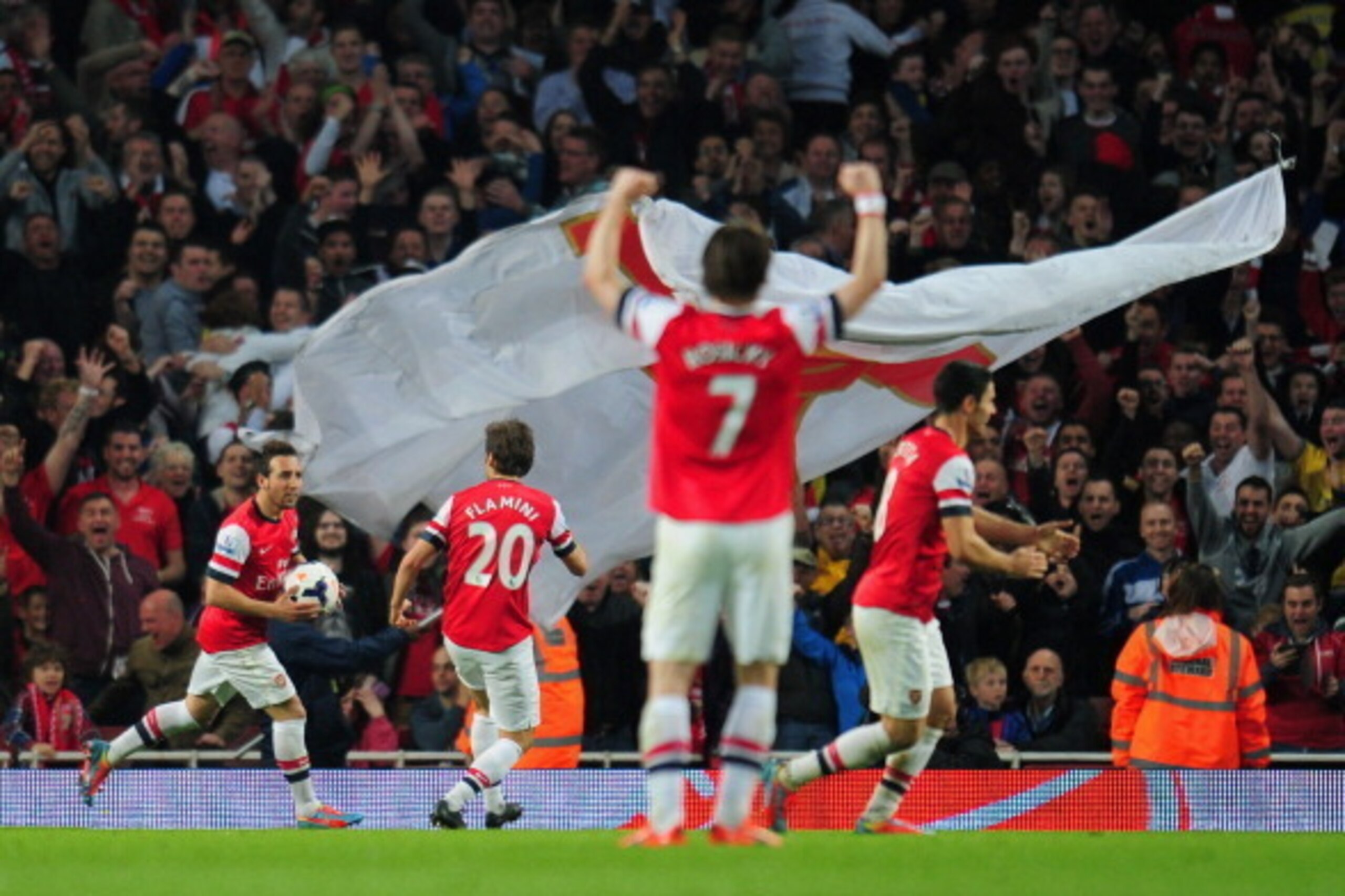 LONDON, ENGLAND - MARCH 29:  Mathieu Flamini of Arsenal celebrates scoring their first goal with Santi Cazorla of Arsenal during the Barclays Premier League match between Arsenal and Manchester City at Emirates Stadium on March 29, 2014 in London, England