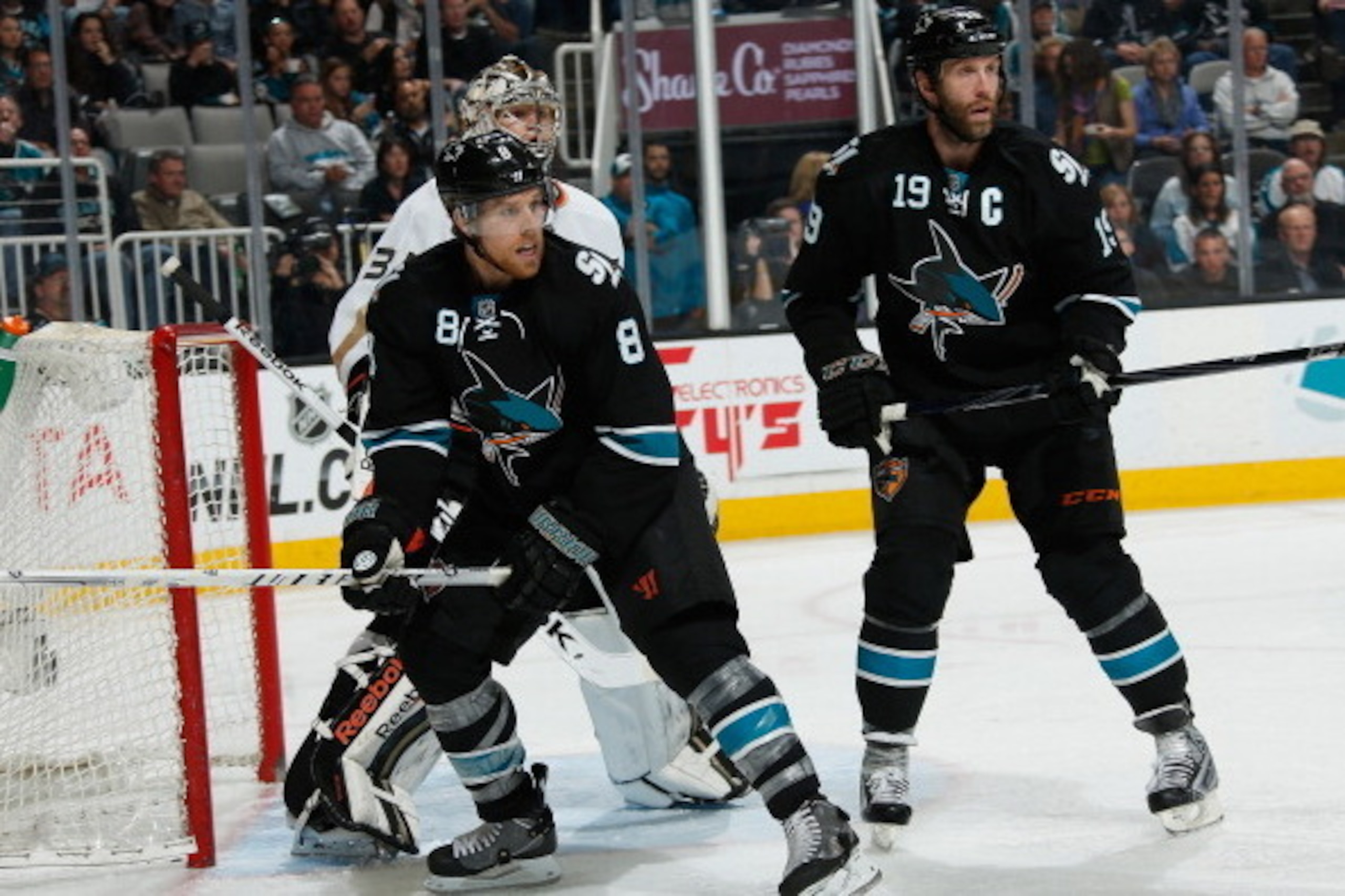 SAN JOSE, CA - MARCH 20: Joe Pavelski #8 and Joe Thornton #19 of the San Jose Sharks create traffic in front of the net against Frederik Andersen #31 of the Anaheim Ducks during an NHL game on March 20, 2014 at SAP Center in San Jose, California. (Photo b