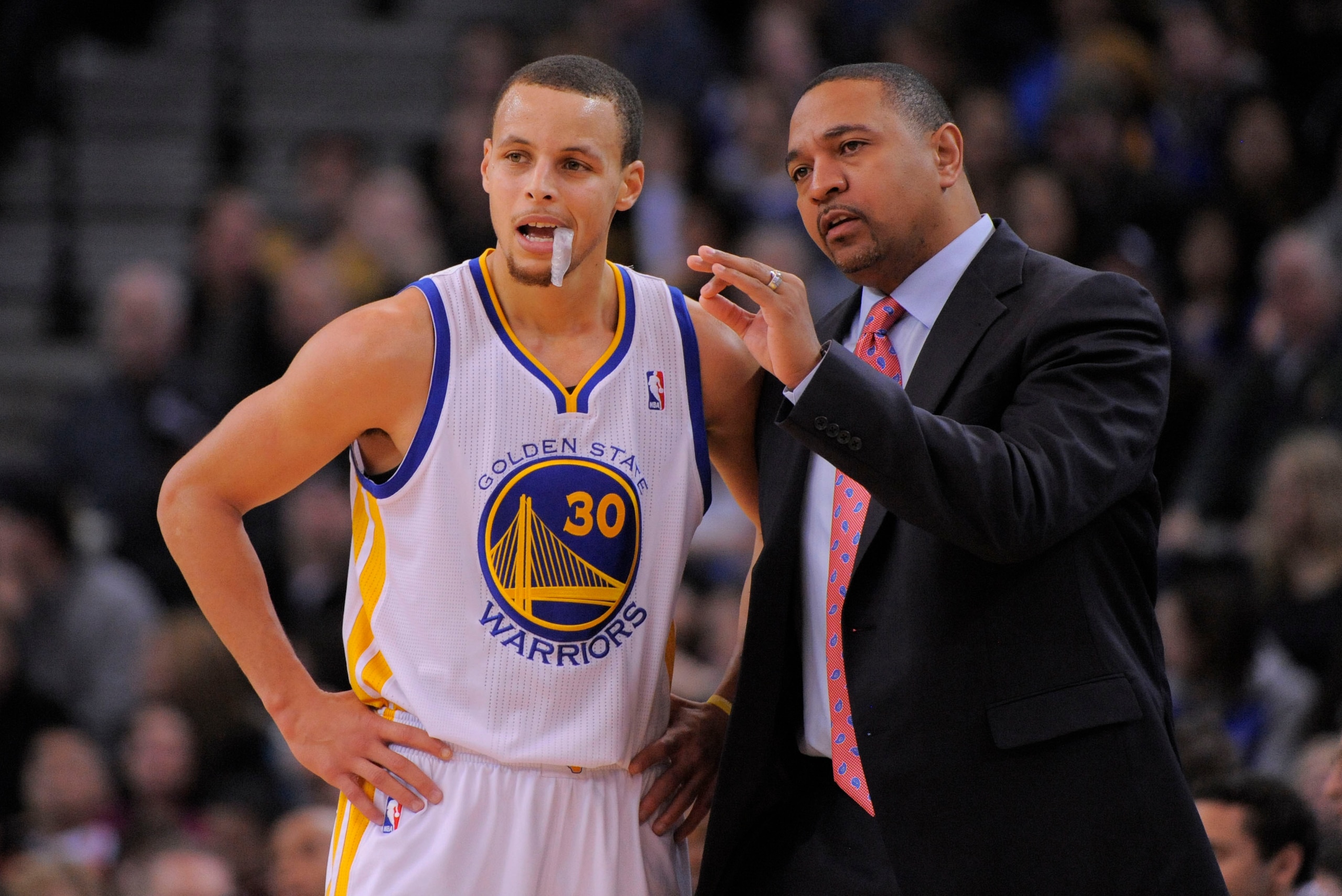 January 11, 2013; Oakland, CA, USA; Golden State Warriors head coach Mark Jackson (right) instructs point guard Stephen Curry (30) during the second quarter against the Portland Trail Blazers at Oracle Arena. Mandatory Credit: Kyle Terada-USA TODAY Sports