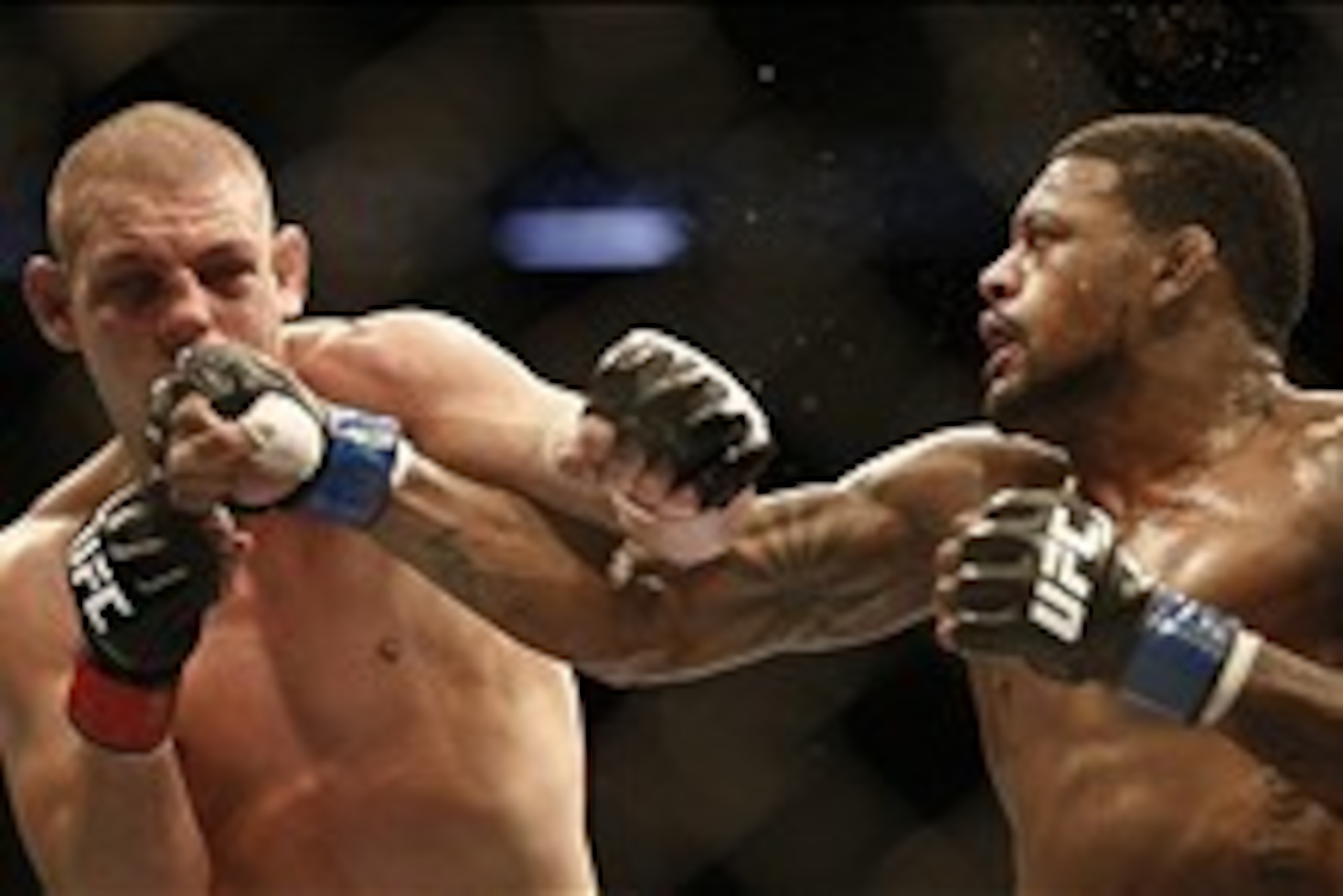 Aug 17, 2013; Boston, MA, USA; Joe Lauzon (left) and Michael Johnson (right) fight during a UFC lightweight match at the TD Garden. Johnson won by judges decision. Mandatory Credit: Winslow Townson-USA TODAY Sports