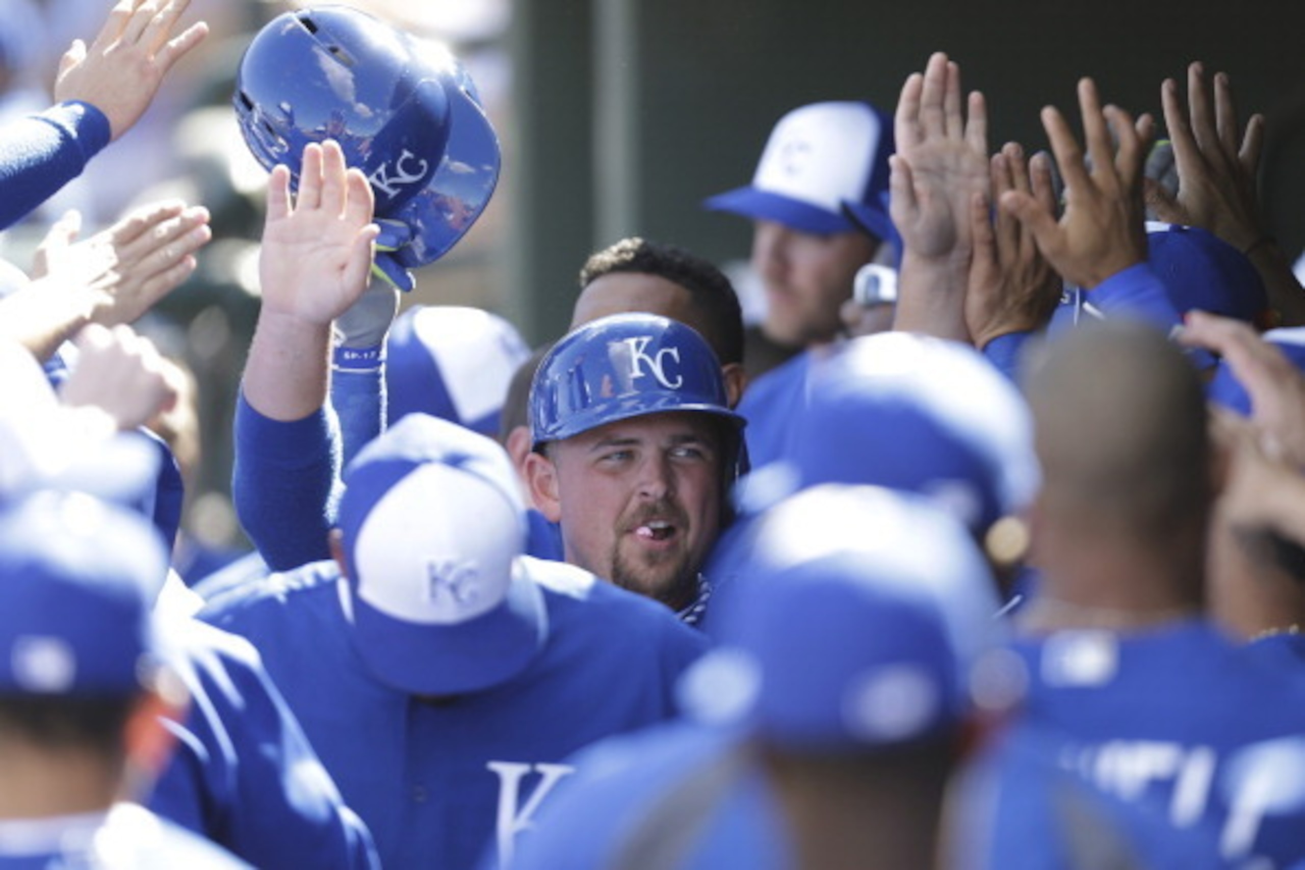 SURPRISE, AZ - FEBRUARY 27: Billy Butler #16 of the Texas Rangers celebrates in the dugout after reaching on a sacrifice fly hit by Salvador Perez against the Kansas City Royals at Surprise Stadium on February 27, 2014 in Surprise, Arizona. (Photo by Mike