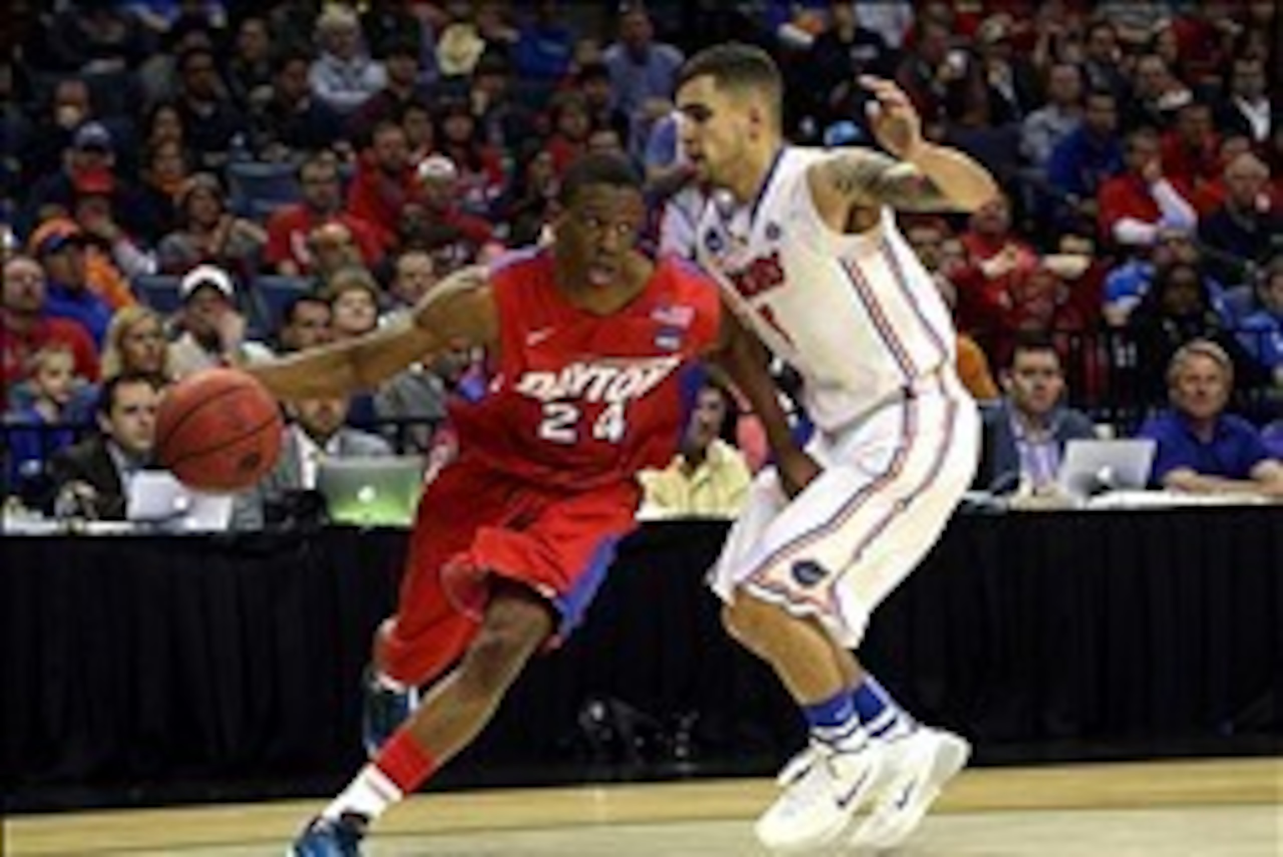Mar 29, 2014; Memphis, TN, USA; Dayton Flyers guard Jordan Sibert (24) drives against Florida Gators guard Scottie Wilbekin (5) during the second half in the finals of the south regional of the 2014 NCAA Mens Basketball Championship tournament at FedEx Fo