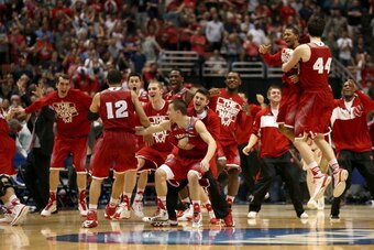 ANAHEIM, CA - MARCH 29:  Traevon Jackson #12 and Frank Kaminsky #44 of the Wisconsin Badgers celebrate with teammates after defeating the Arizona Wildcats 64-63 in overtime during the West Regional Final of the 2014 NCAA Men's Basketball Tournament at the