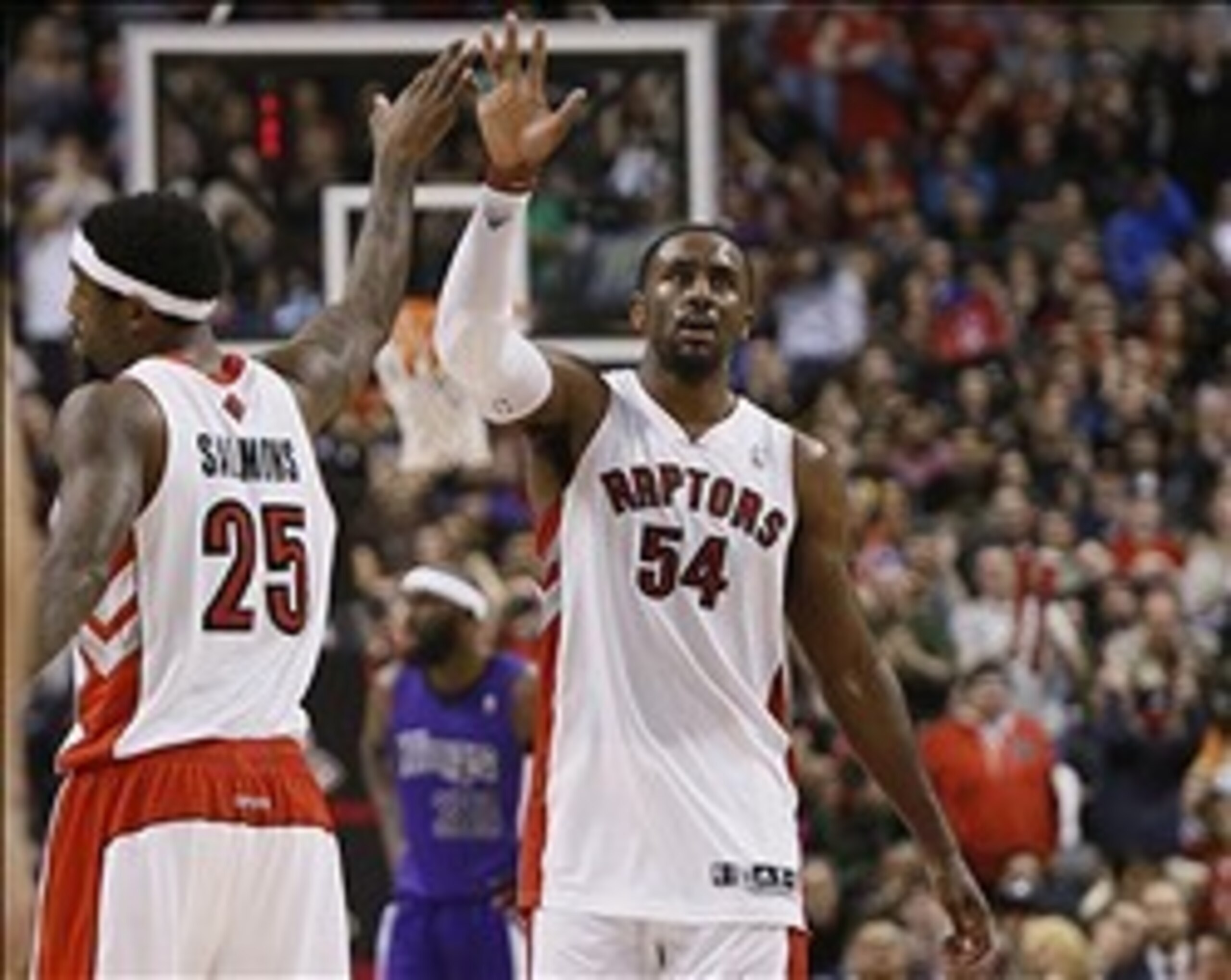 Mar 7, 2014; Toronto, Ontario, CAN; Toronto Raptors guard-forward John Salmons (25) congratulates forward Patrick Patterson (54) after a play against the Sacramento Kings during the second half at the Air Canada Centre. Toronto defeated Sacramento 99-87.