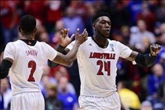 Mar 28, 2014; Indianapolis, IN, USA; Louisville Cardinals guard Russ Smith (2) celebrates with forward Montrezl Harrell (24) in the first half in the semifinals of the midwest regional of the 2014 NCAA Mens Basketball Championship tournament against the K