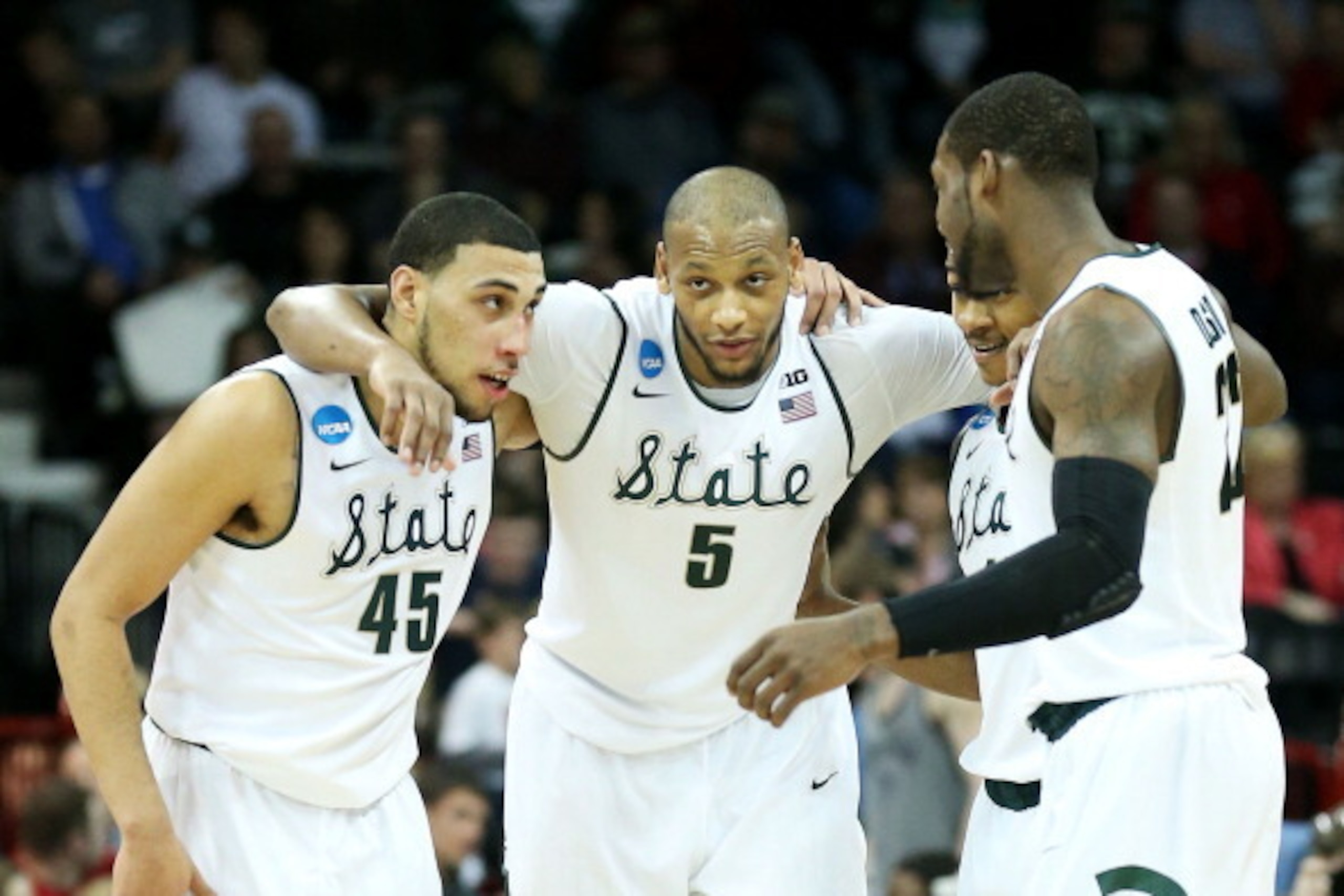 SPOKANE, WA - MARCH 22: Denzel Valentine #45 Adreian Payne #5, Keith Appling #11 and Branden Dawson #22 of the Michigan State Spartans celebrate in the second half of their 80 to 73 win over the Harvard Crimson during the Third Round of the 2014 NCAA Bas SPOKANE, WA - MARCH 22: Denzel Valentine #45 Adreian Payne #5, Keith Appling #11 and Branden Dawson #22 of the Michigan State Spartans celebrate in the second half of their 80 to 73 win over the Harvard Crimson during the Third Round of the 2014 NCAA Bas