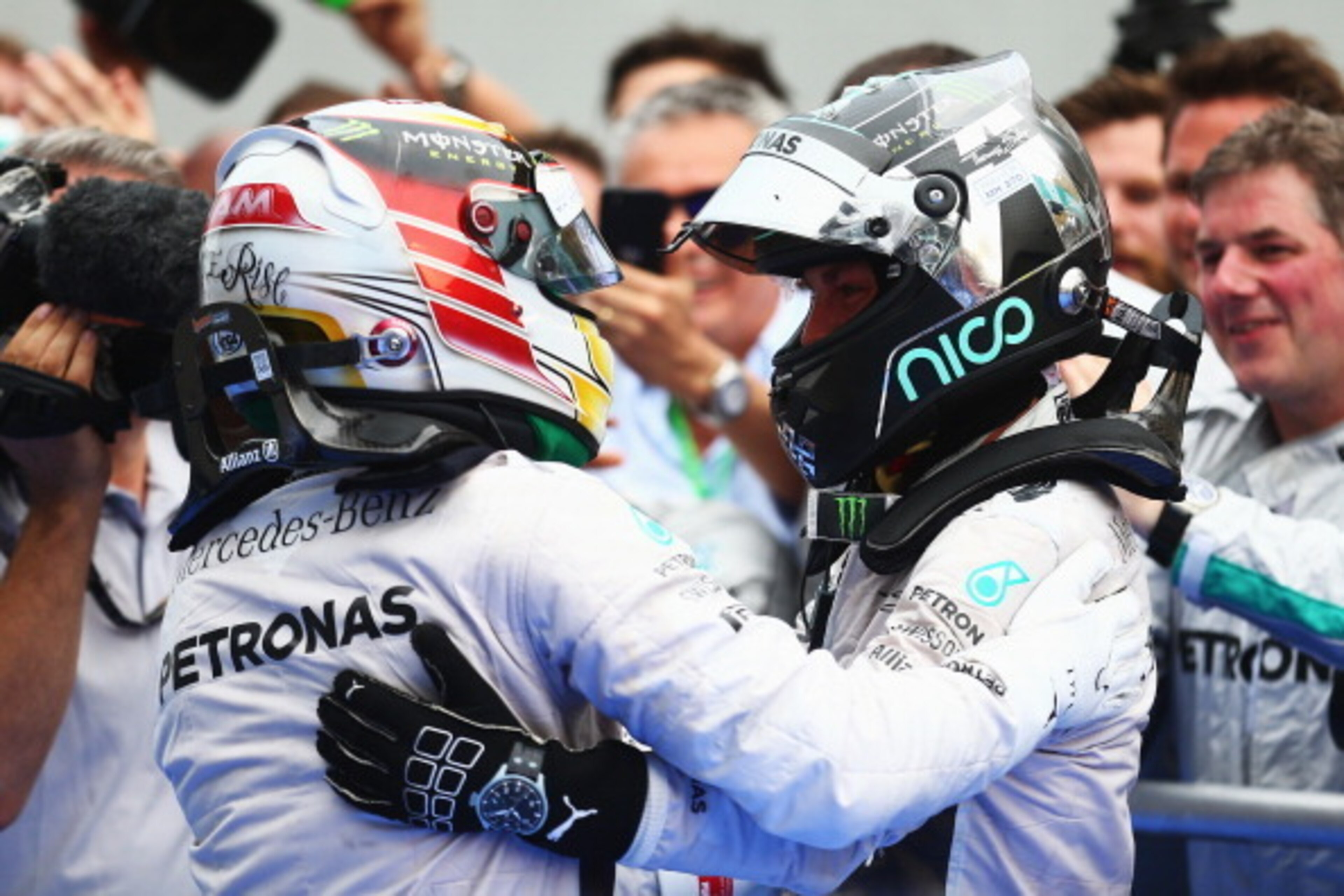 KUALA LUMPUR, MALAYSIA - MARCH 30:  Lewis Hamilton of Great Britain and Mercedes GP (L) celebrates victory with team mate and second placed Nico Rosberg of Germany and Mercedes GP after the Malaysia Formula One Grand Prix at the Sepang Circuit on March 30