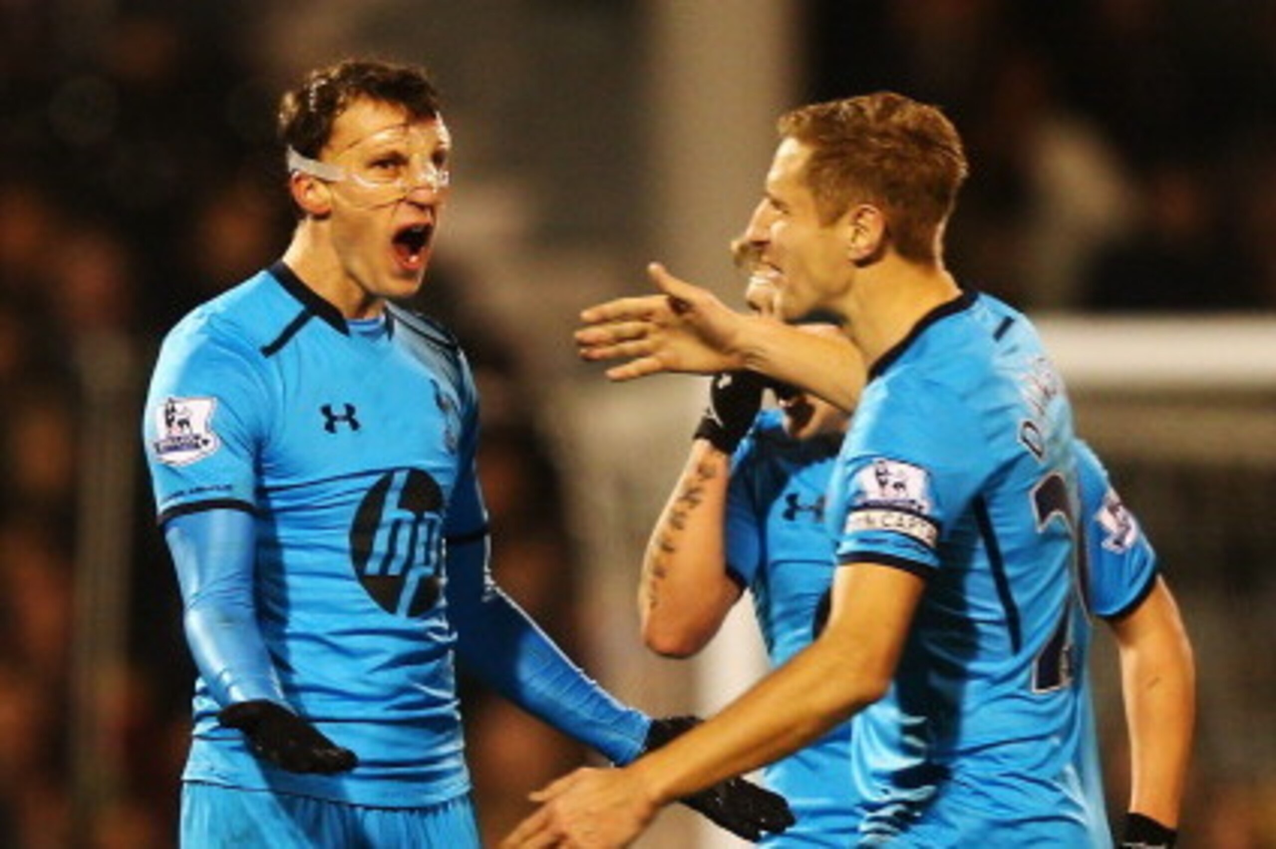 LONDON, ENGLAND - DECEMBER 04:  Vlad Chiriches (L) of Tottenham Hotspur celebrates with team mate Lewis Holtby (C) and Michael Dawson (R) after equalising during the Barclays Premier League match between Fulham and Tottenham Hotspur at Craven Cottage on D