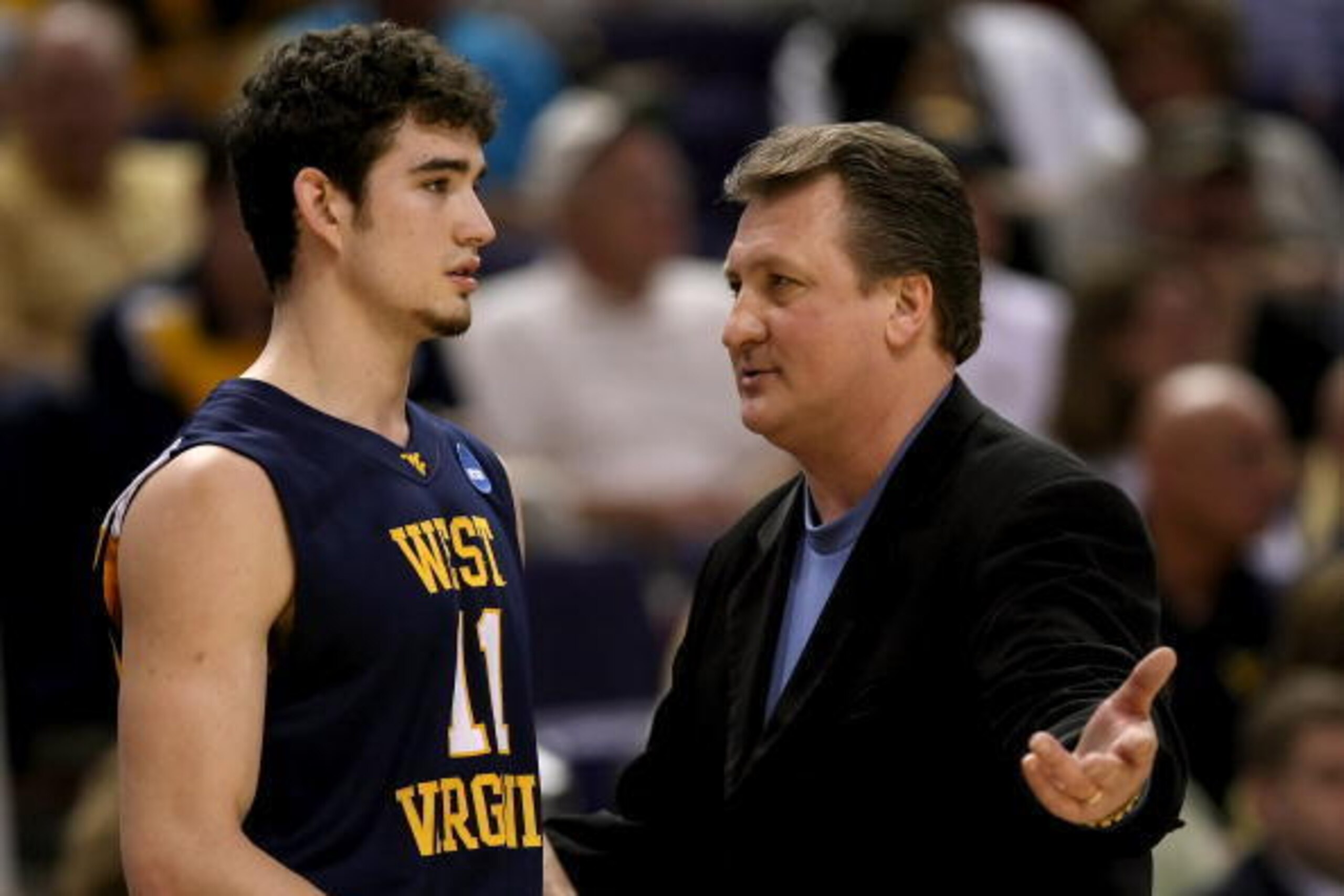 PHOENIX - MARCH 27:  Head coach Bob Huggins of West Virginia Mountaineers talks to player Joe Alexander #11 during the first half of the West Regional Sweet 16 game against the Xavier Musketeers at the U.S. Airways Center on March 27, 2008 in Phoenix, Ari