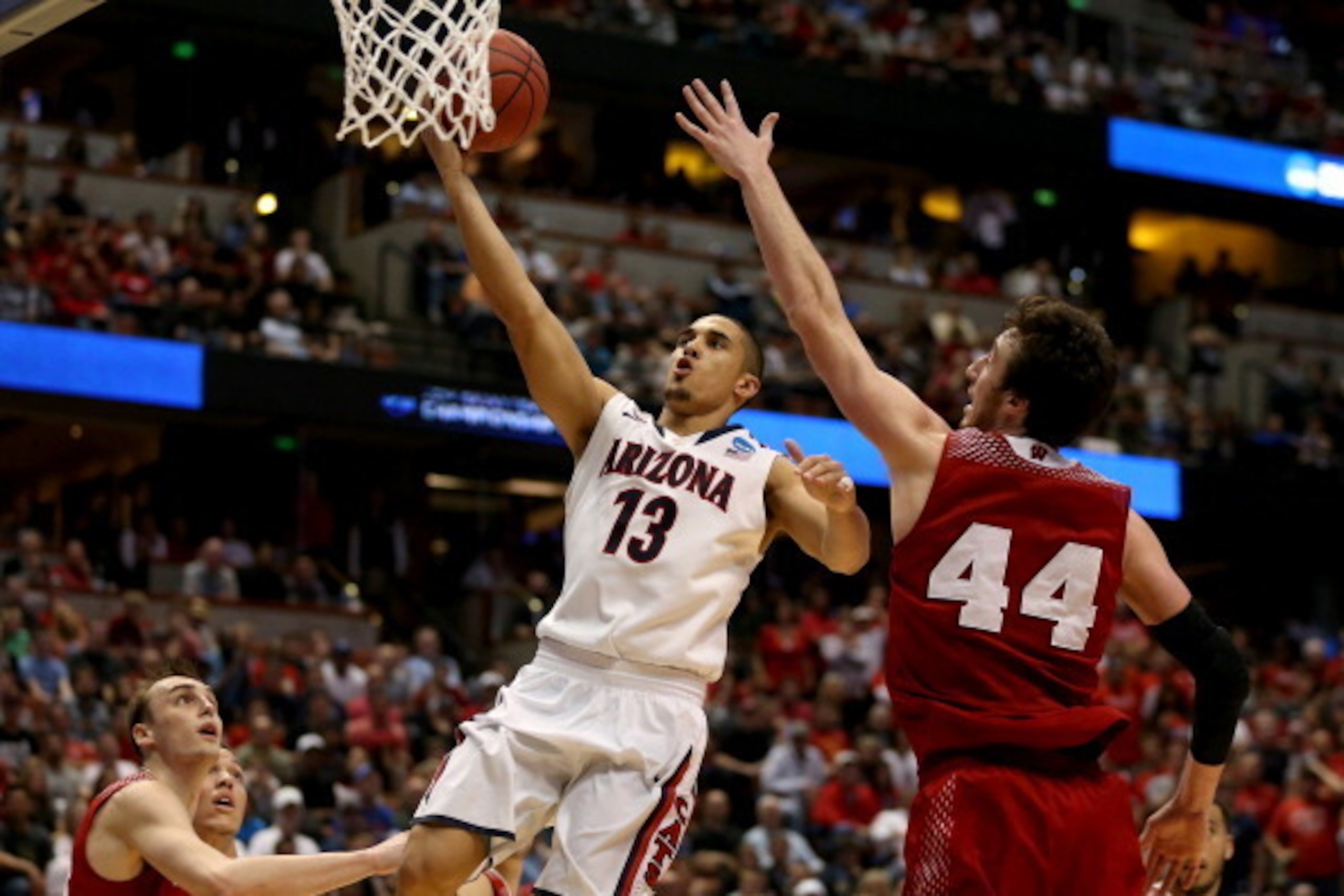 ANAHEIM, CA - MARCH 29:  Nick Johnson #13 of the Arizona Wildcats goes up for a shot against Frank Kaminsky #44 of the Wisconsin Badgers in the second half during the West Regional Final of the 2014 NCAA Men's Basketball Tournament at the Honda Center on