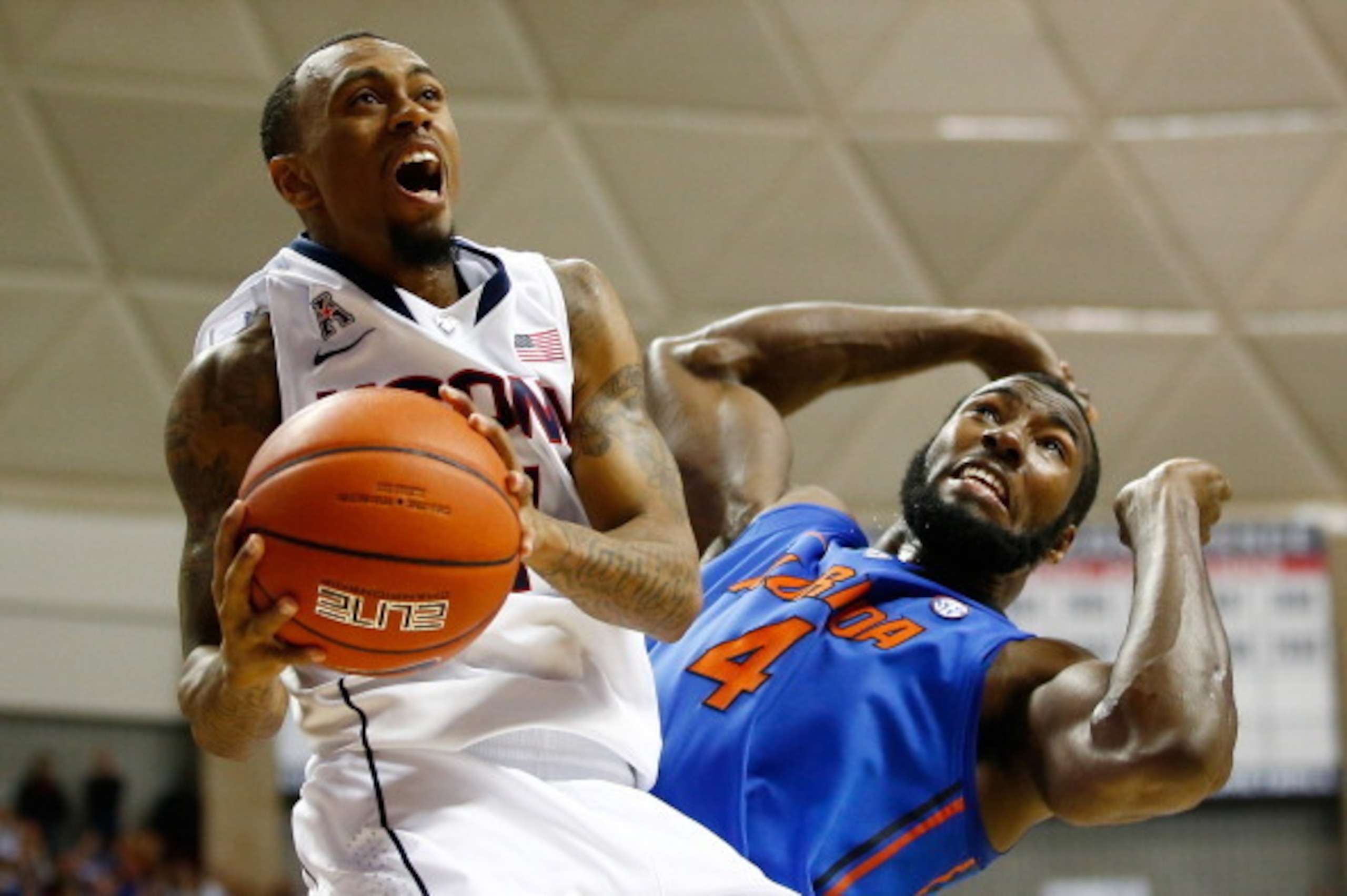 STORRS, CT - DECEMBER 02: Ryan Boatright #11 of the Connecticut Huskies drives to the basket in front of Patric Young #4 of the Florida Gators in the second half during the game at Harry A. Gampel Pavilion on December 2, 2013 in Storrs, Connecticut.  (Pho