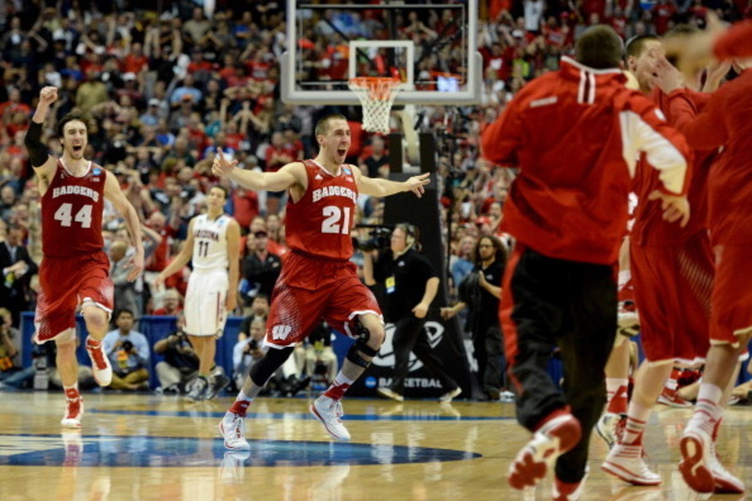 ANAHEIM, CA - MARCH 29:  Josh Gasser #21 and Frank Kaminsky #44 of the Wisconsin Badgers celebrate after defeating the Arizona Wildcats 64-63 in overtime during the West Regional Final of the 2014 NCAA Men's Basketball Tournament at the Honda Center on Ma