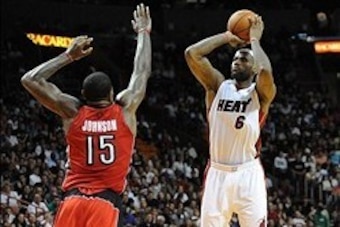 Jan 5, 2014; Miami, FL, USA; Miami Heat small forward LeBron James (6) shoots over Toronto Raptors power forward Amir Johnson (15) during the second half at American Airlines Arena. Miami won 102-97. Mandatory Credit: Steve Mitchell-USA TODAY Sports
