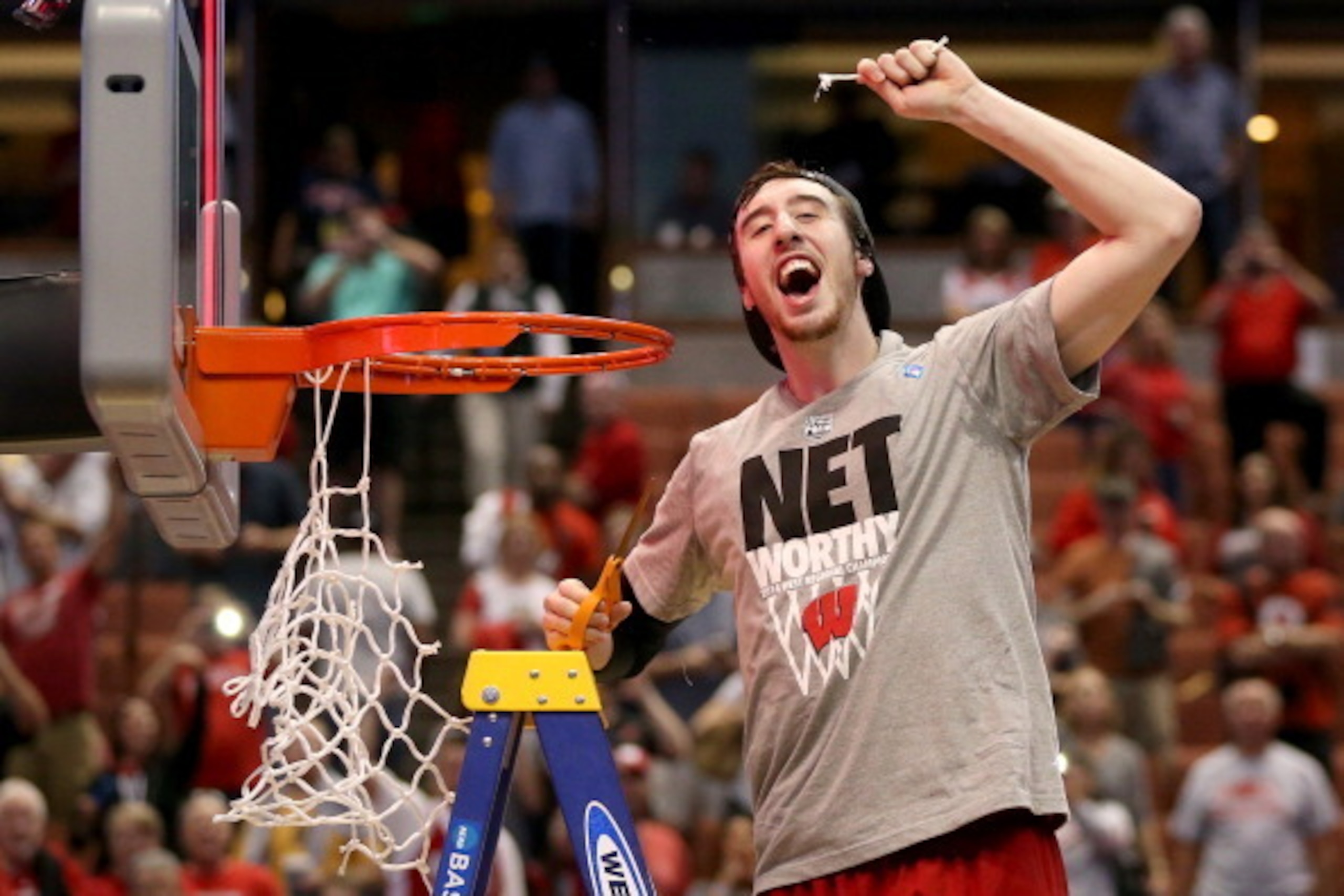 ANAHEIM, CA - MARCH 29:  Frank Kaminsky #44 of the Wisconsin Badgers celebrates after he cuts down the net after defeating the Arizona Wildcats 64-63 in overtime during the West Regional Final of the 2014 NCAA Men's Basketball Tournament at the Honda Cent
