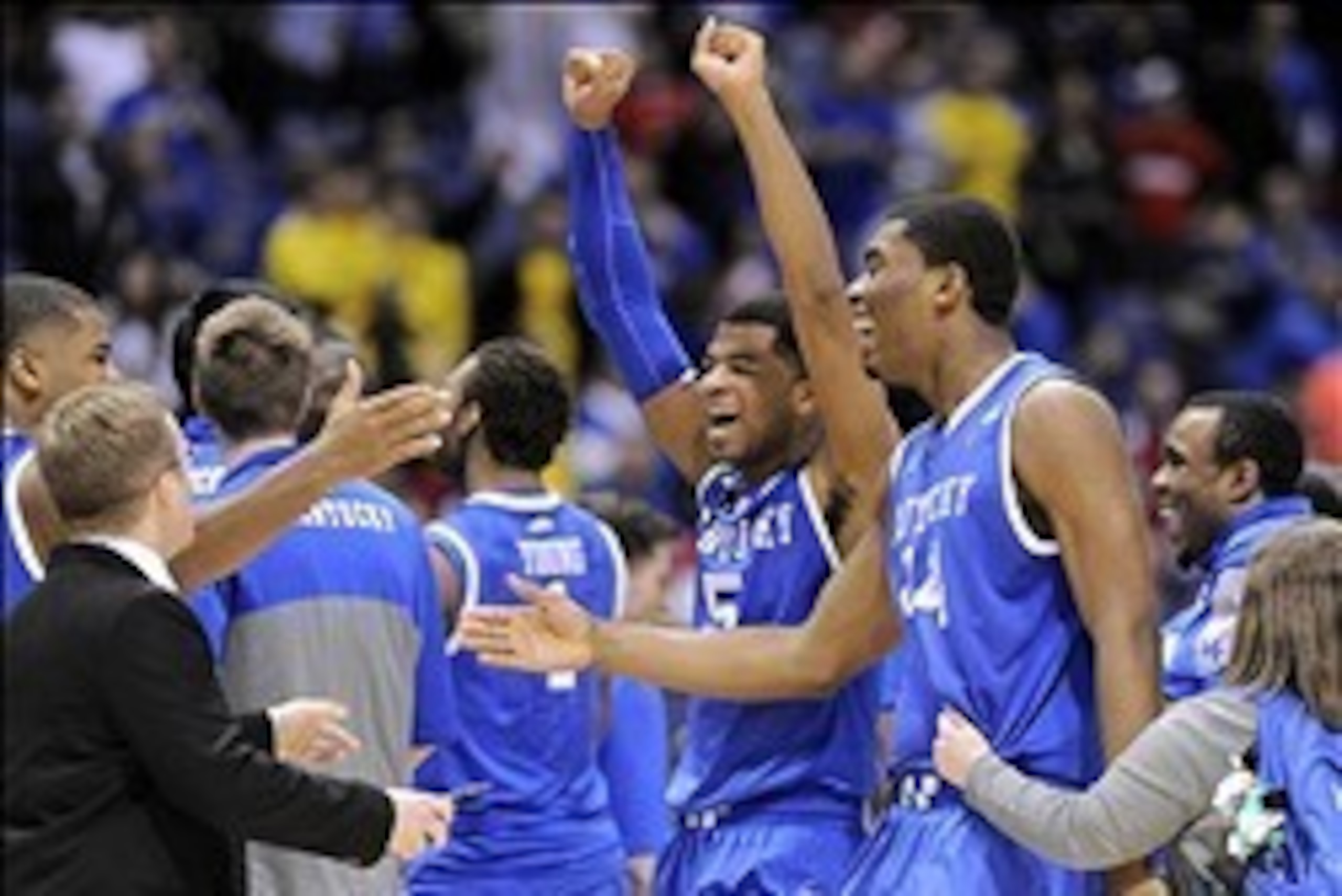 Mar 28, 2014; Indianapolis, IN, USA; Kentucky Wildcats guard Andrew Harrison (5) and center Dakari Johnson (44) celebrate with teammates after defeating the Louisville Cardinals in the semifinals of the midwest regional of the 2014 NCAA Mens Basketball Ch