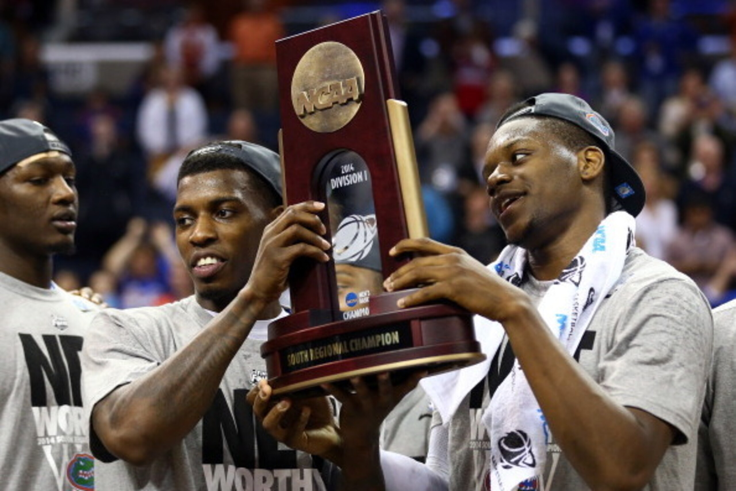 MEMPHIS, TN - MARCH 29: Casey Prather #24 and Will Yeguete #15 of the Florida Gators celebrate with the trophy after defeating the Dayton Flyers 62-52 in the south regional final of the 2014 NCAA Men's Basketball Tournament at the FedExForum on March 29, MEMPHIS, TN - MARCH 29: Casey Prather #24 and Will Yeguete #15 of the Florida Gators celebrate with the trophy after defeating the Dayton Flyers 62-52 in the south regional final of the 2014 NCAA Men's Basketball Tournament at the FedExForum on March 29,