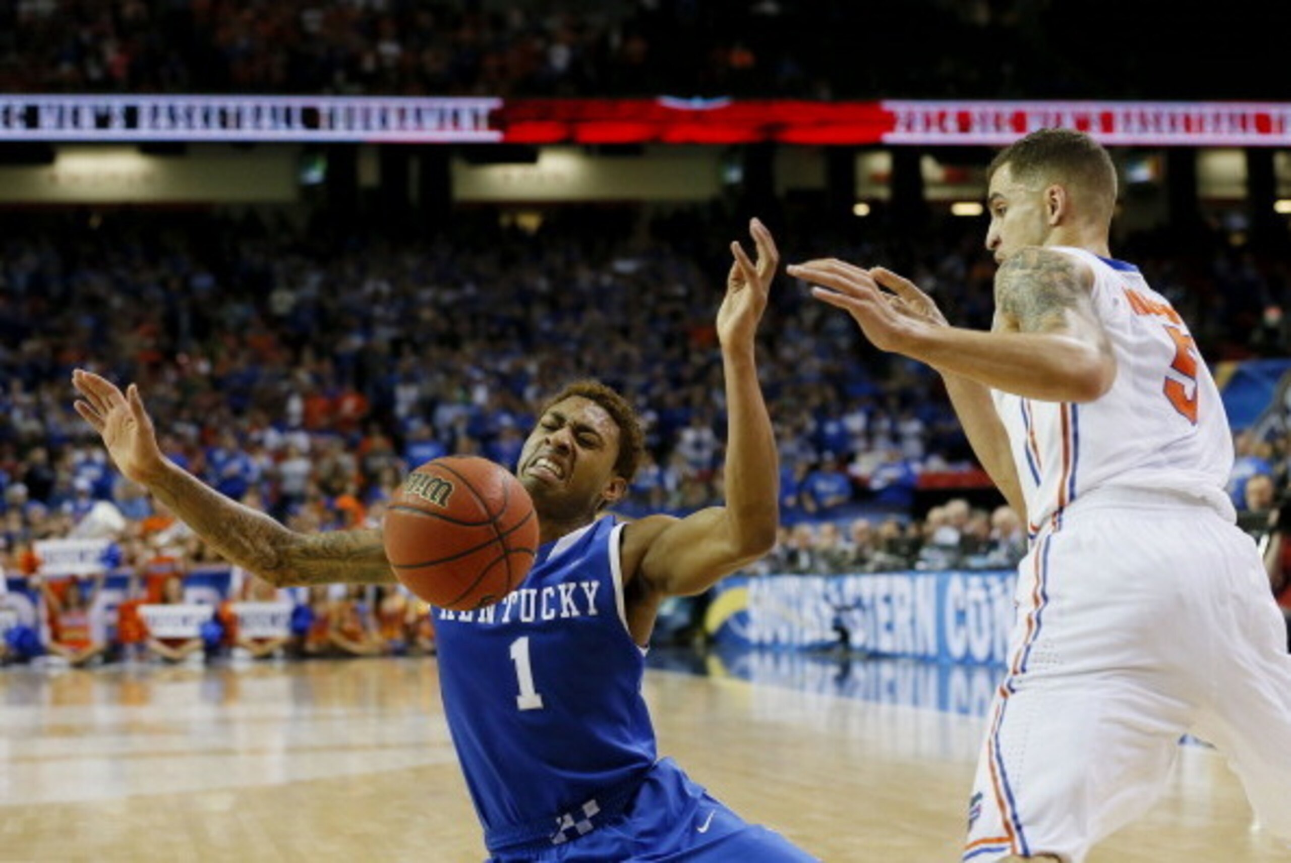 ATLANTA, GA - MARCH 16:  Scottie Wilbekin #5 of the Florida Gators fouls James Young #1 of the Kentucky Wildcats in the second half during the Championship game of the 2014 Men's SEC Basketball Tournament at Georgia Dome on March 16, 2014 in Atlanta, Geor