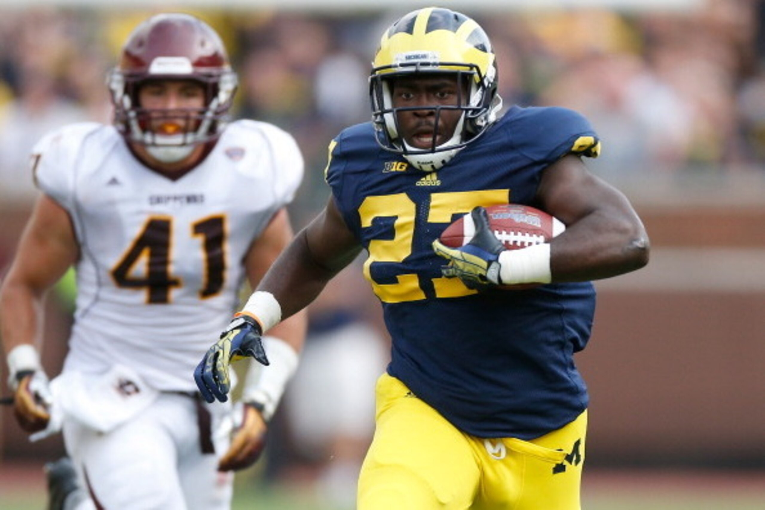ANN ARBOR, MI - AUGUST 31: Derrick Green #27 of the Michigan Wolverines finds some open space while playing Justin Cherocci #41 and the Central Michigan Chippewas at Michigan Stadium on August 31, 2013 in Ann Arbor, Michigan.  (Photo by Gregory Shamus/Get