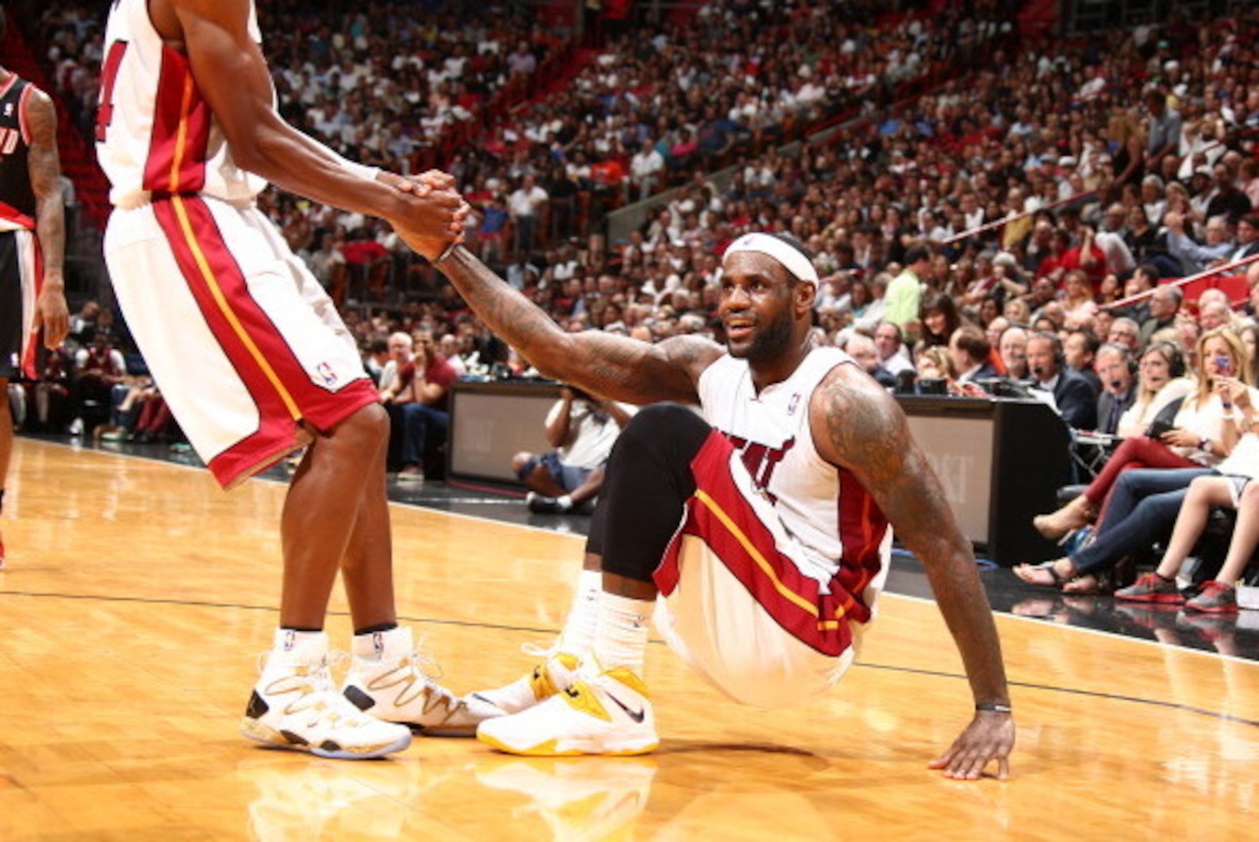 MIAMI, FL - MARCH 24:  Ray Allen #34 helps up LeBron James #6 of the Miami Heat during the game against the Portland Trail Blazers on March 24, 2014 at American Airlines Arena in Miami, Florida.  NOTE TO USER: User expressly acknowledges and agrees that, 