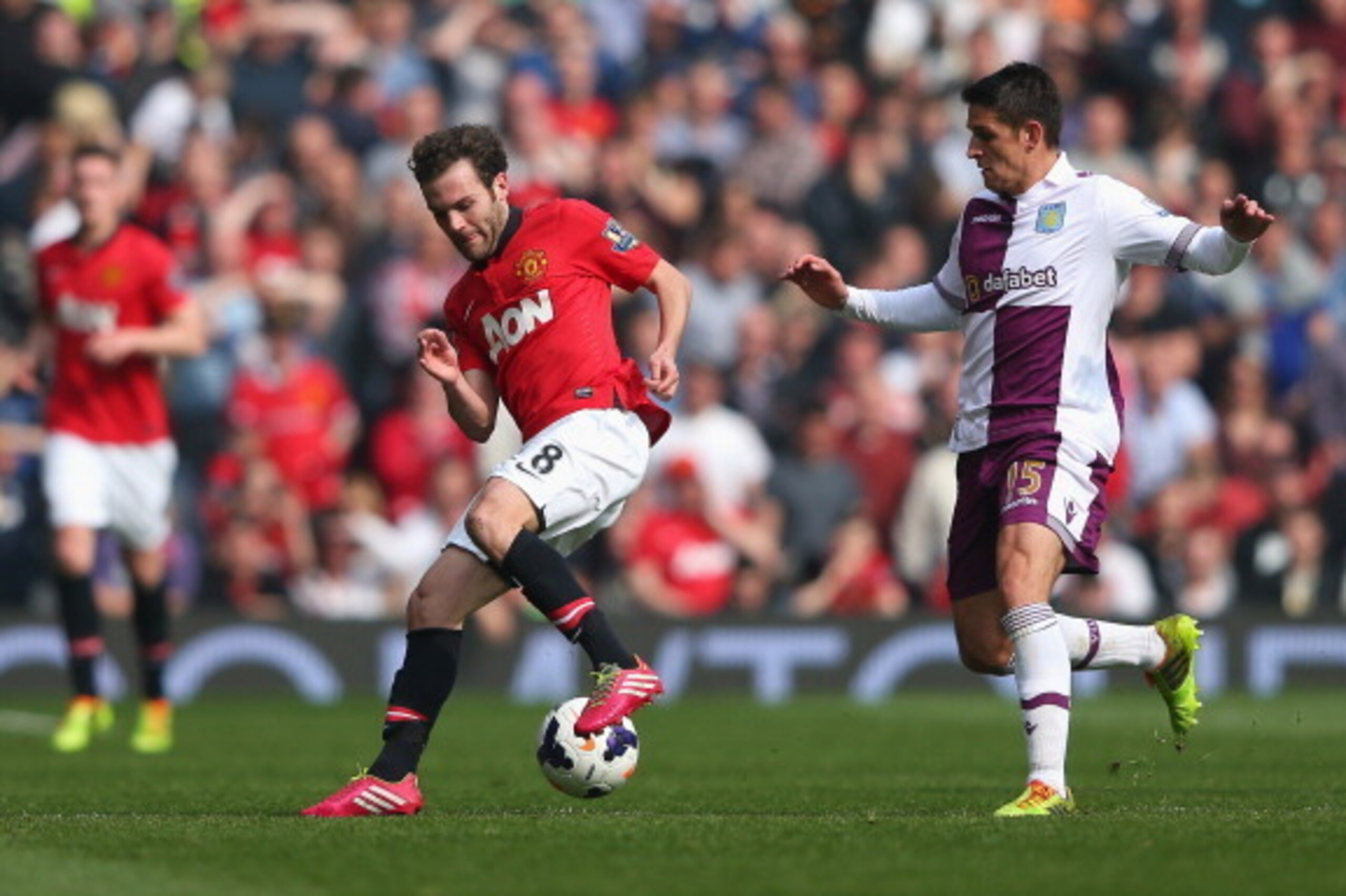 MANCHESTER, ENGLAND - MARCH 29:  Ashley Westwood of Aston Villa competes with Juan Mata of Manchester United during the Barclays Premier League match between Manchester United and Aston Villa at Old Trafford on March 29, 2014 in Manchester, England.  (Pho