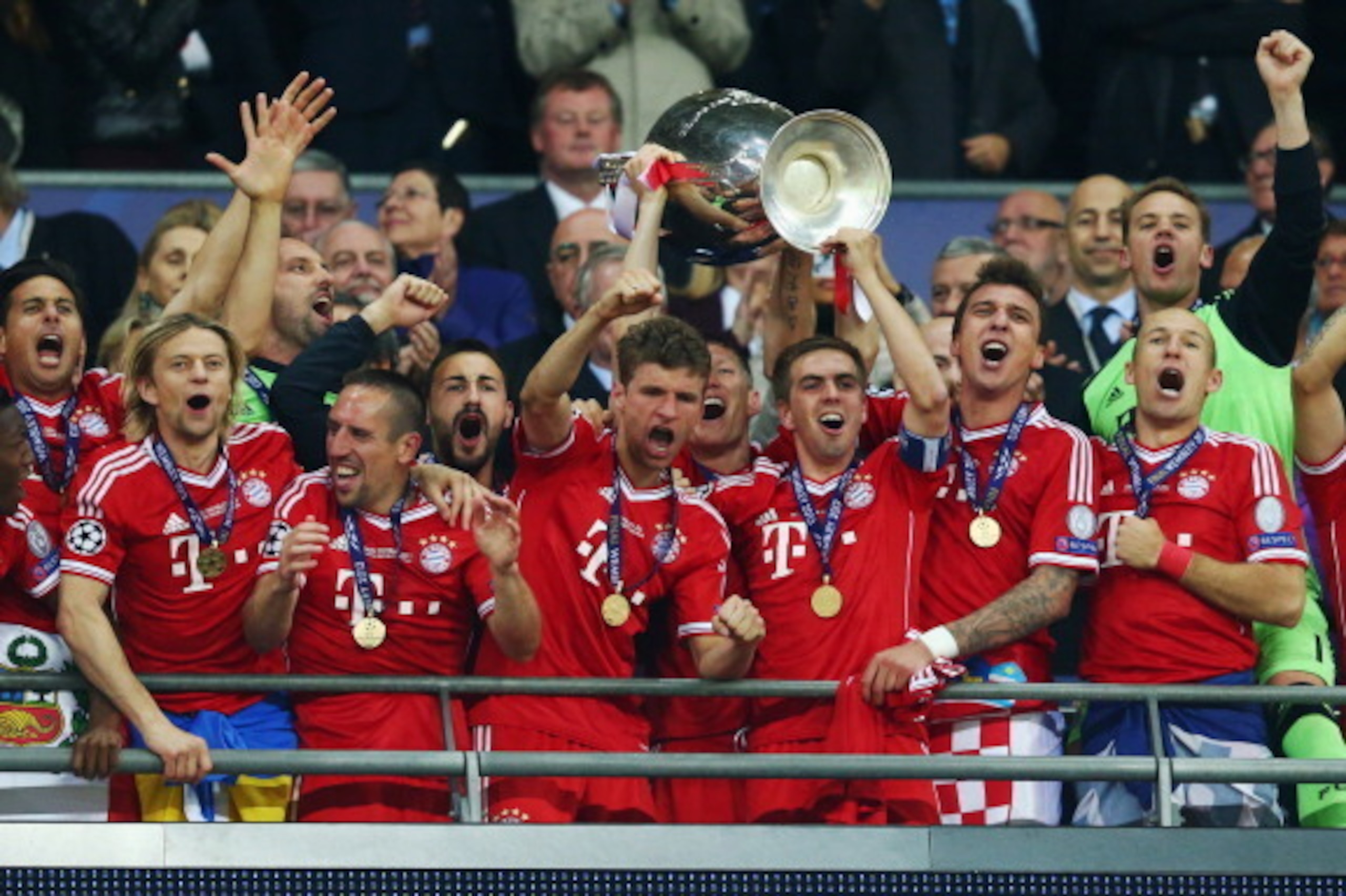 LONDON, ENGLAND - MAY 25:  Bastian Schweinsteiger, Thomas Mueller and Philipp Lahm of Bayern Muenchen lift the trophy in celebration alongside team mates after victory in the UEFA Champions League final match between Borussia Dortmund and FC Bayern Muench