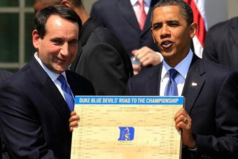 WASHINGTON - MAY 27:  U.S. President Barack Obama (R) is presented with a plaque of a bracket by coach Mike Krzyzewski (L) of the Duke Blue Devils during a Rose Garden event May 27, 2010 at the White House in Washington, DC. Obama hosted the NCAA men bask