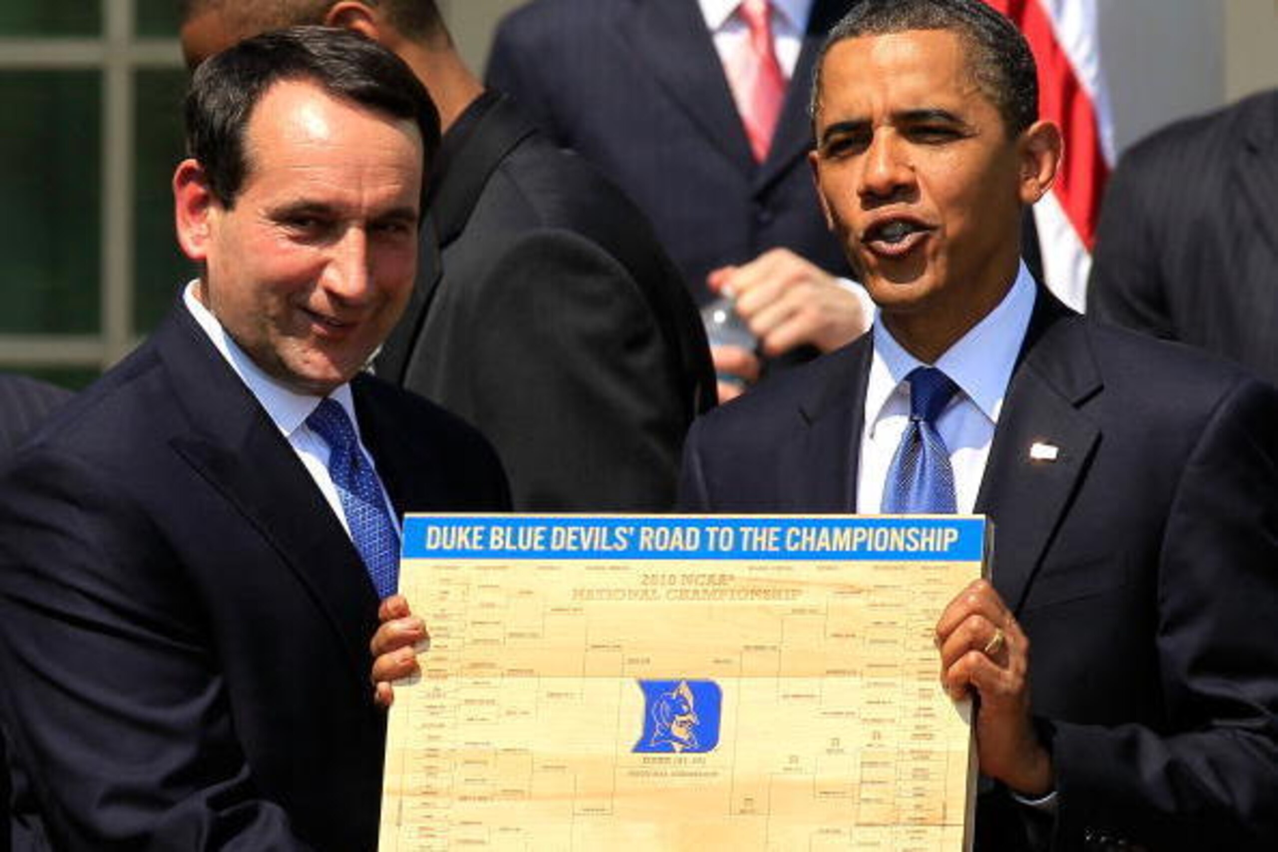 WASHINGTON - MAY 27:  U.S. President Barack Obama (R) is presented with a plaque of a bracket by coach Mike Krzyzewski (L) of the Duke Blue Devils during a Rose Garden event May 27, 2010 at the White House in Washington, DC. Obama hosted the NCAA men bask