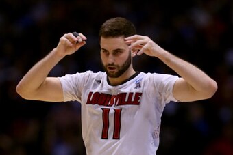 INDIANAPOLIS, IN - MARCH 28:  Luke Hancock #11 of the Louisville Cardinals reacts against the Kentucky Wildcats during the regional semifinal of the 2014 NCAA Men's Basketball Tournament at Lucas Oil Stadium on March 28, 2014 in Indianapolis, Indiana.  (P