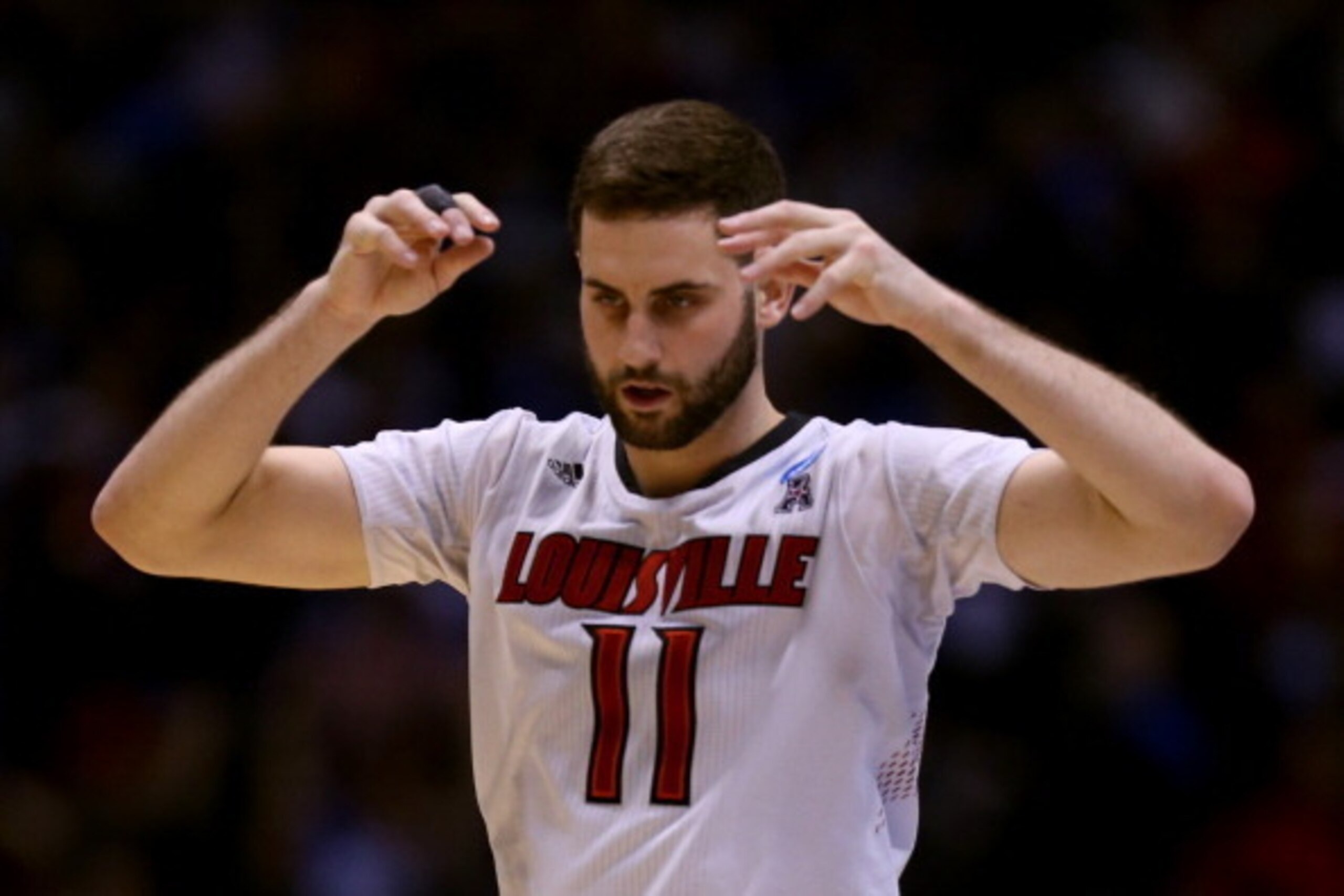 INDIANAPOLIS, IN - MARCH 28:  Luke Hancock #11 of the Louisville Cardinals reacts against the Kentucky Wildcats during the regional semifinal of the 2014 NCAA Men's Basketball Tournament at Lucas Oil Stadium on March 28, 2014 in Indianapolis, Indiana.  (P