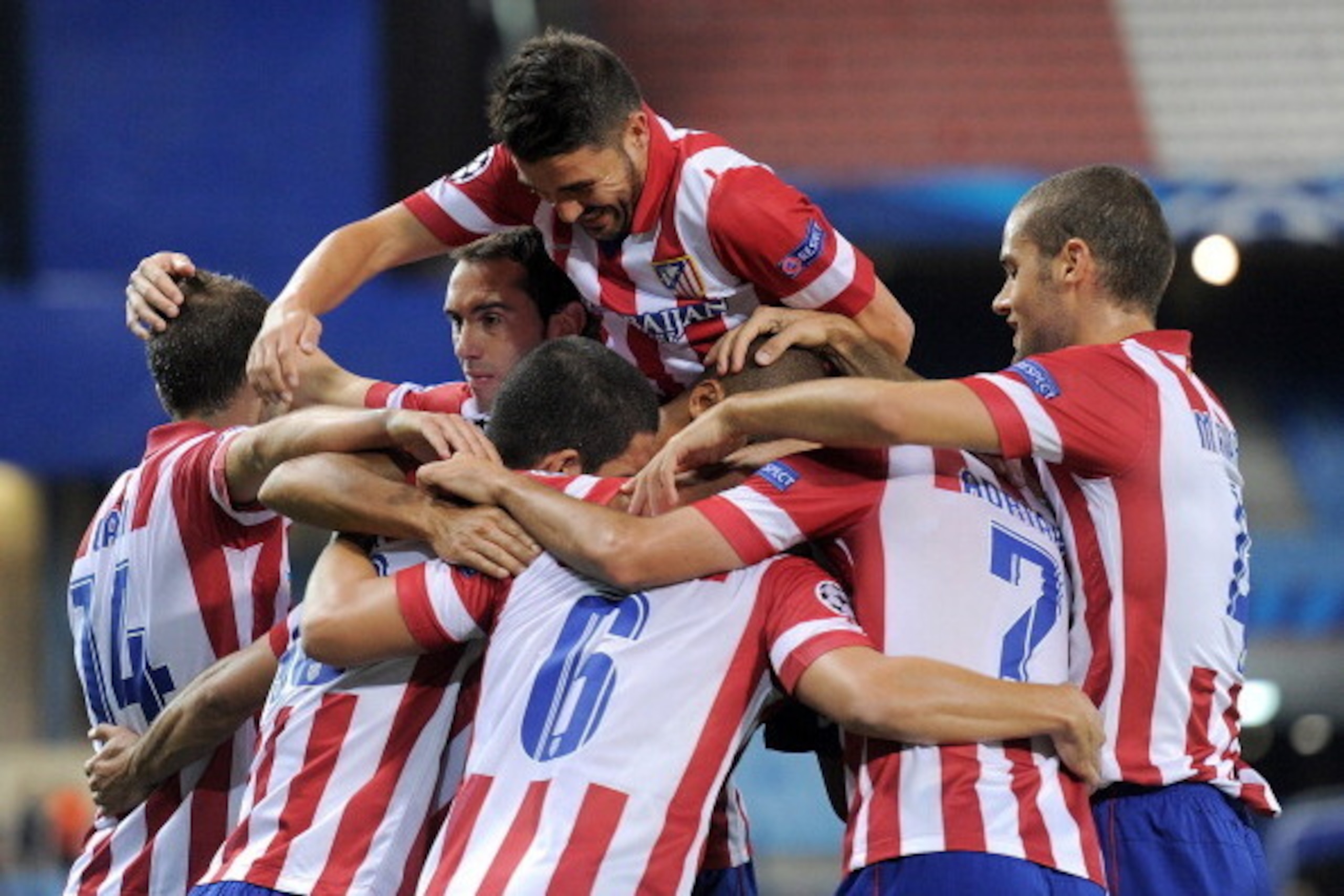 MADRID, SPAIN - SEPTEMBER 18:  Joao Miranda (unseen) of Club Atletico de Madrid celebrates with team-mates after scoring his team's opening goal during the UEFA Champions League Group G match between Club Atletico de Madrid and FC Zenit at Vicente Caldero
