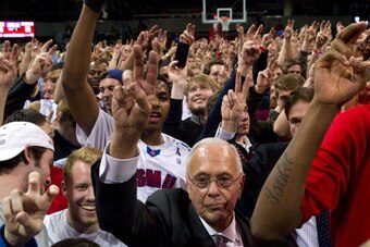 DALLAS, TX - FEBRUARY 8:  Head coach Larry Brown of the SMU Mustangs celebrates with fans after defeating the Cincinnati Bearcats on February 8, 2014 at Moody Coliseum in Dallas, Texas.  (Photo by Cooper Neill/Getty Images)
