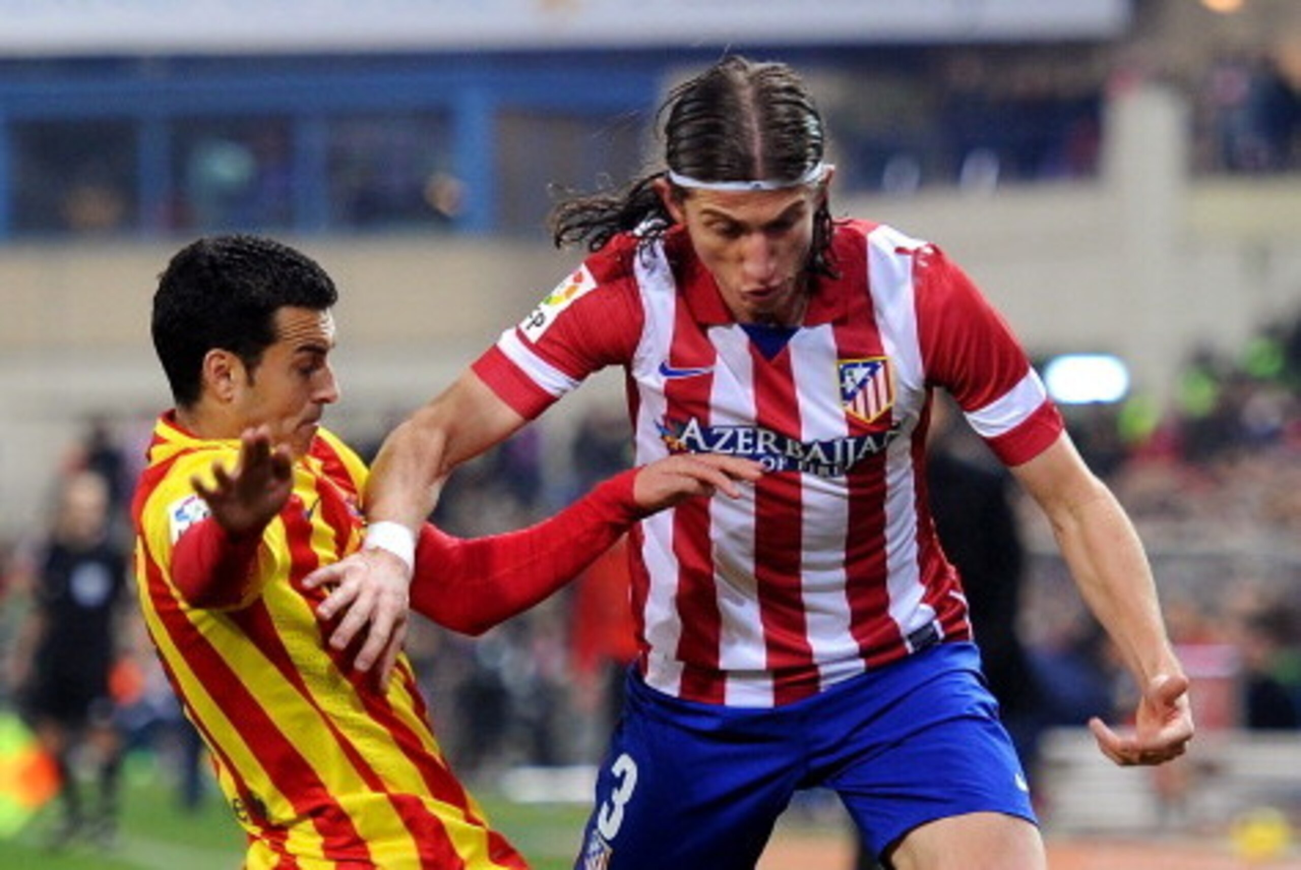MADRID, SPAIN - JANUARY 11:  Pedro Rodriguez (L) of FC Barcelona tackles Felipe Luis of Club Atletico de Madrid of Club Atletico de Madrid during the La Liga match between Club Atletico de Madrid and FC Barcelona  at Vicente Calderon Stadium on January 11
