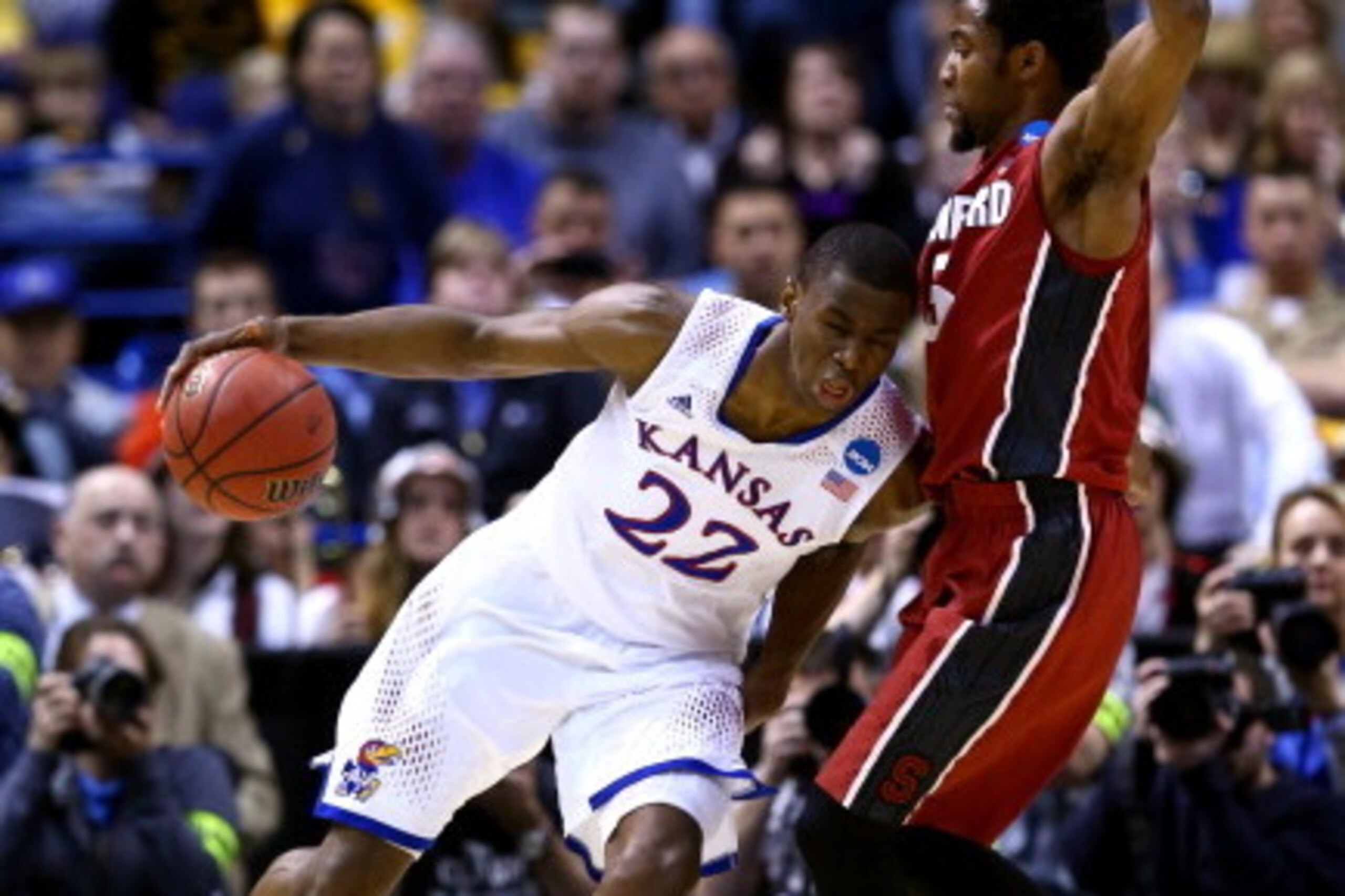 ST LOUIS, MO - MARCH 23:  Andrew Wiggins #22 of the Kansas Jayhawks drives against Chasson Randle #5 of the Stanford Cardinal during the third round of the 2014 NCAA Men's Basketball Tournament at Scottrade Center on March 23, 2014 in St Louis, Missouri. 