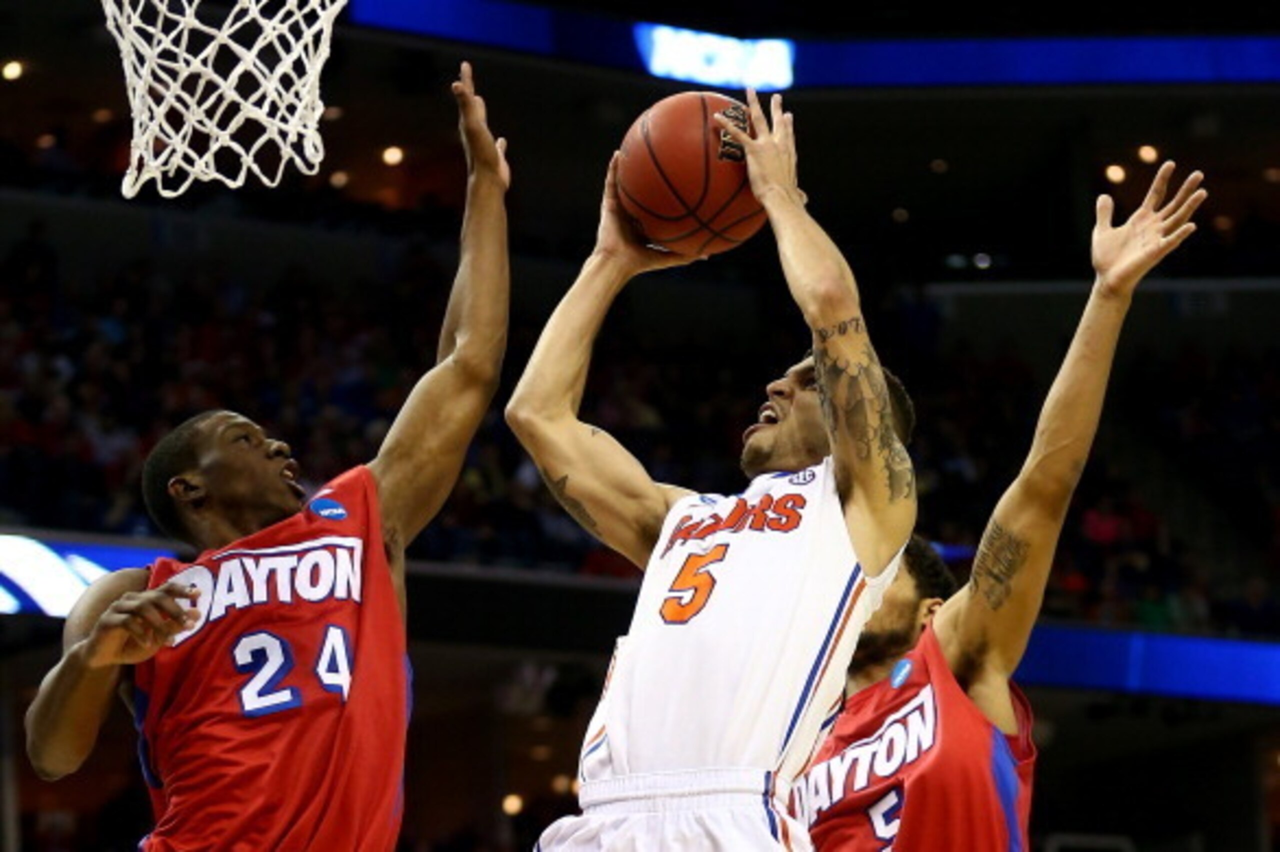 MEMPHIS, TN - MARCH 29:  Scottie Wilbekin #5 of the Florida Gators goes to the basket as Jordan Sibert #24 and Devin Oliver #5 of the Dayton Flyers defend during the south regional final of the 2014 NCAA Men's Basketball Tournament at the FedExForum on Ma