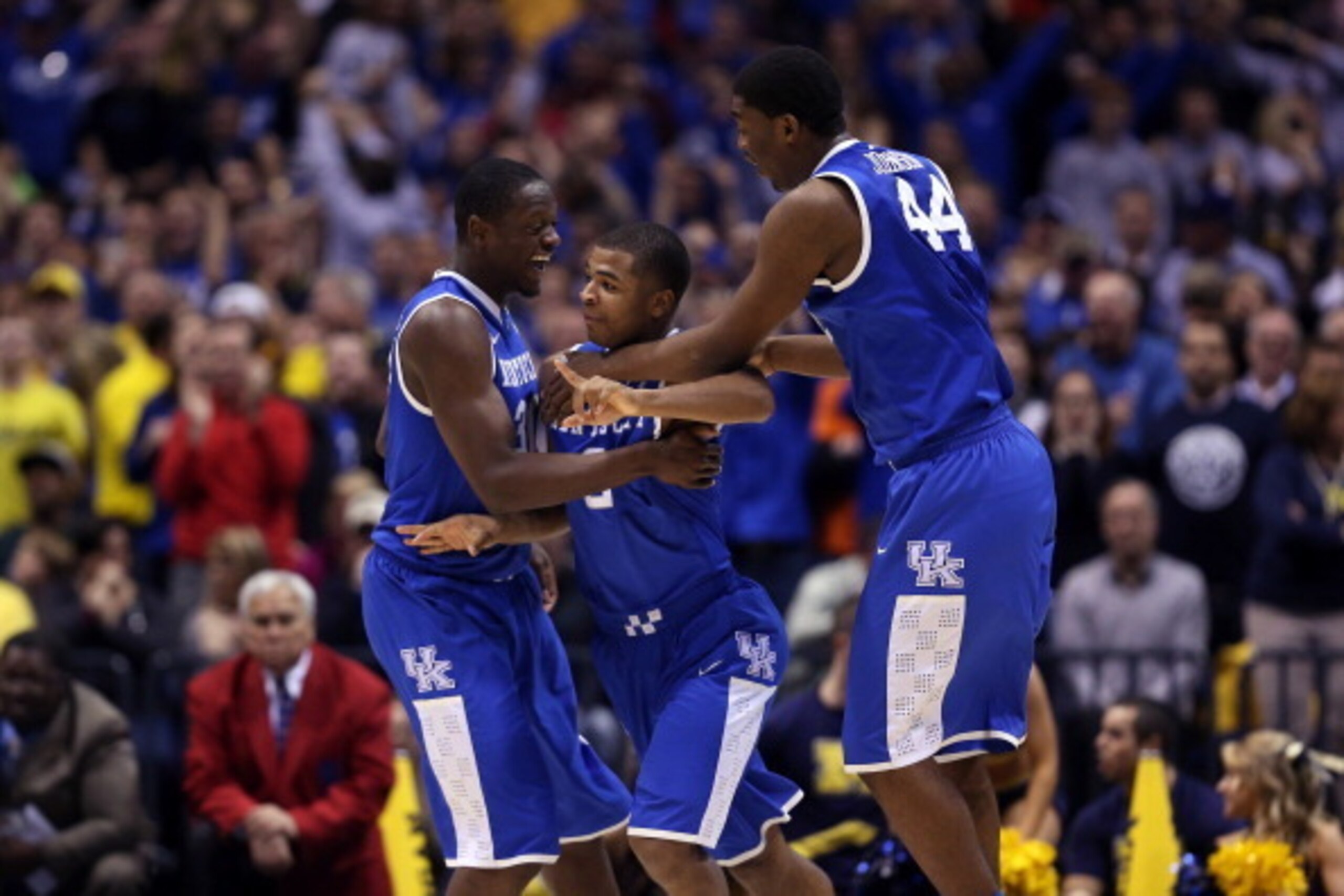INDIANAPOLIS, IN - MARCH 30:  Aaron Harrison #2 of the Kentucky Wildcats celebrates with teammates Julius Randle #30 and Dakari Johnson after defeating the Michigan Wolverines 75 to 72 in the midwest regional final of the 2014 NCAA Men's Basketball Tourna