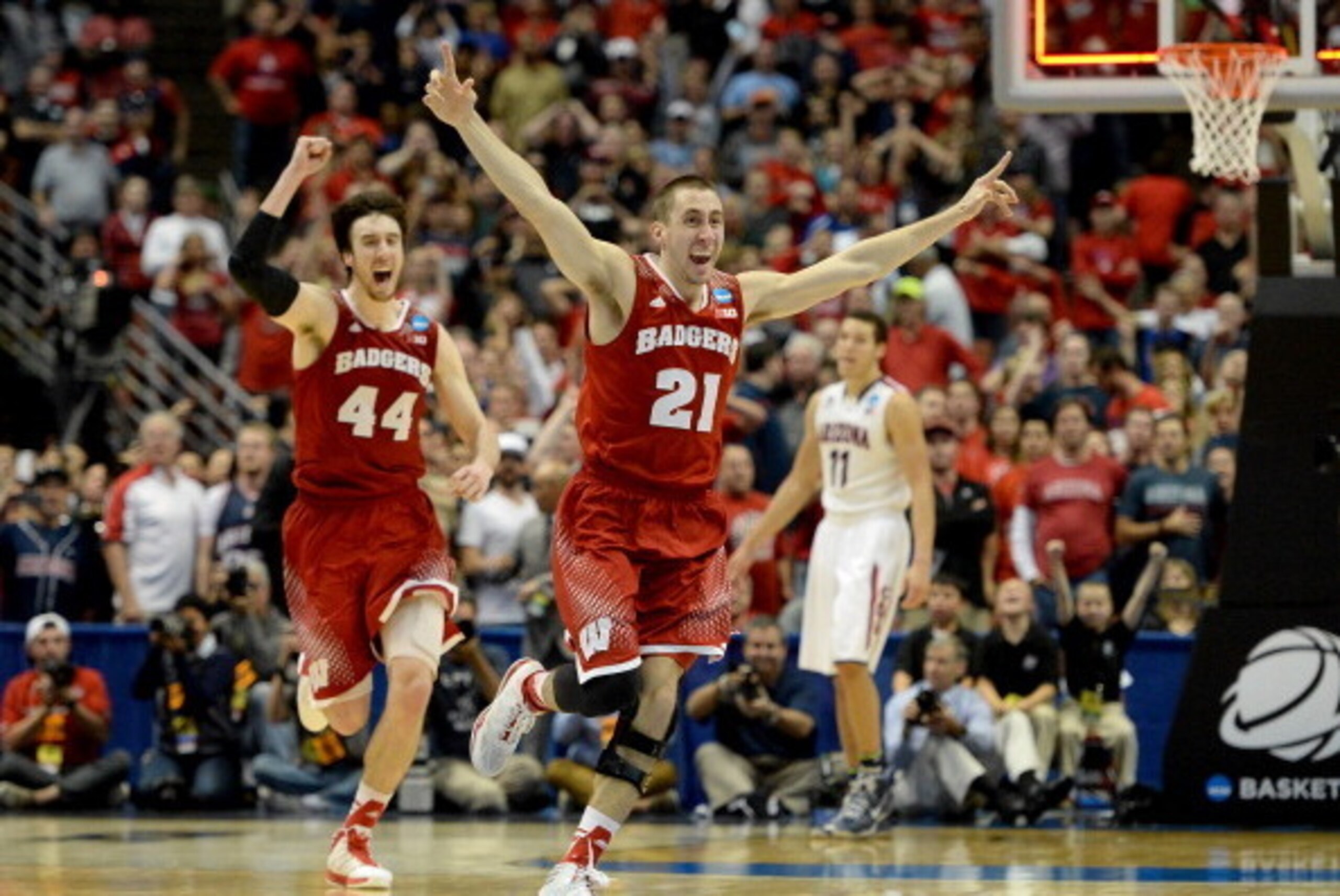 ANAHEIM, CA - MARCH 29:  Josh Gasser #21 and Frank Kaminsky #44 of the Wisconsin Badgers celebrate after defeating the Arizona Wildcats 64-63 in overtime during the West Regional Final of the 2014 NCAA Men's Basketball Tournament at the Honda Center on Ma