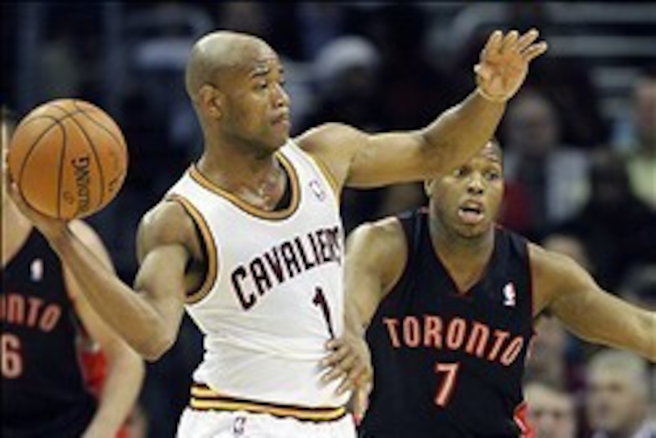 Mar 25, 2014; Cleveland, OH, USA; Cleveland Cavaliers guard Jarrett Jack (1) passes around Toronto Raptors guard Kyle Lowry (7) during the third quarter at Quicken Loans Arena. The Cavaliers won 102-100. Mandatory Credit: Ron Schwane-USA TODAY Sports