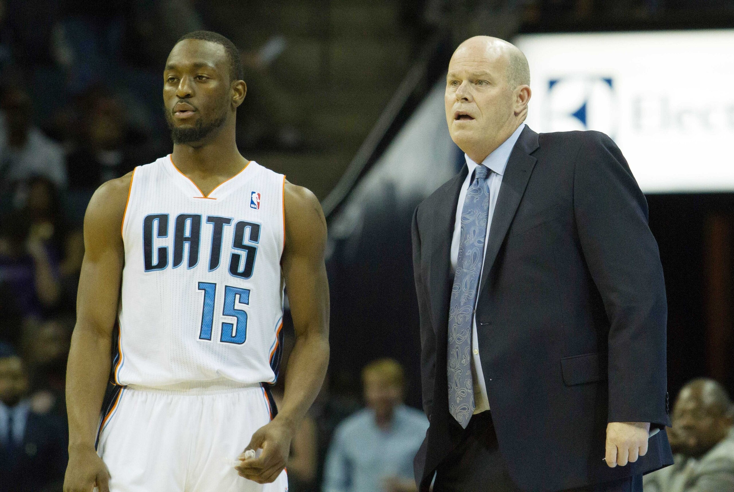 Mar 22, 2014; Charlotte, NC, USA; Charlotte Bobcats head coach Steve Clifford talks with guard Kemba Walker (15) during the first half against the Portland Trail Blazers at Time Warner Cable Arena. Mandatory Credit: Jeremy Brevard-USA TODAY Sports