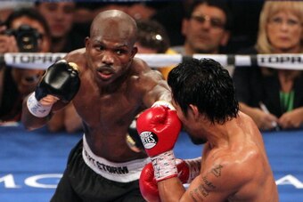 LAS VEGAS, NV - JUNE 09:  (L-R) Timothy Bradley lands a left to the head of Manny Pacquiao during their WBO welterweight title fight at MGM Grand Garden Arena on June 9, 2012 in Las Vegas, Nevada.  (Photo by Jeff Bottari/Getty Images)