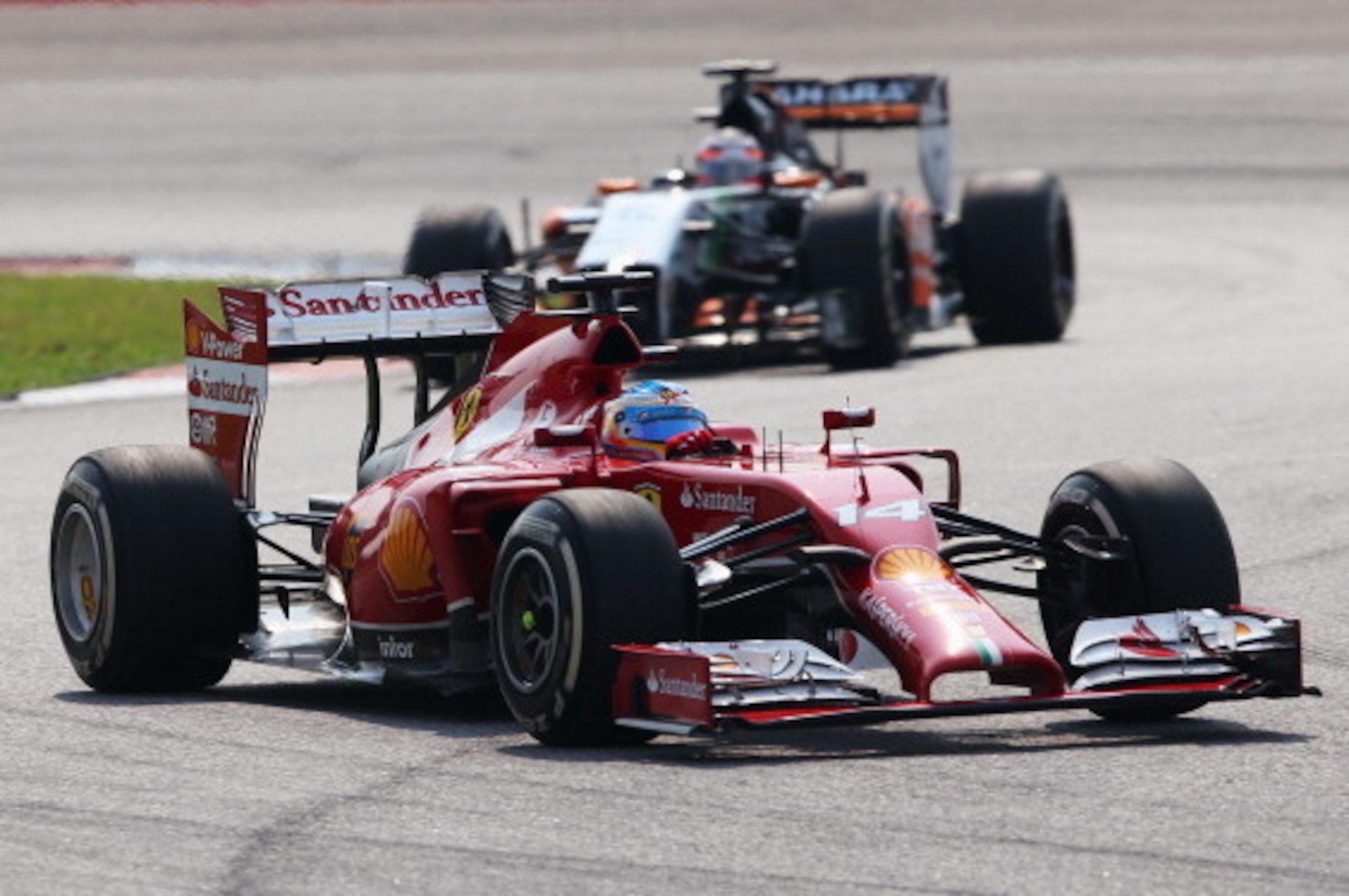 KUALA LUMPUR, MALAYSIA - MARCH 30:  Fernando Alonso of Spain and Ferrari and Nico Hulkenberg of Germany and Force India race during the Malaysia Formula One Grand Prix at the Sepang Circuit on March 30, 2014 in Kuala Lumpur, Malaysia.  (Photo by Mark Thom