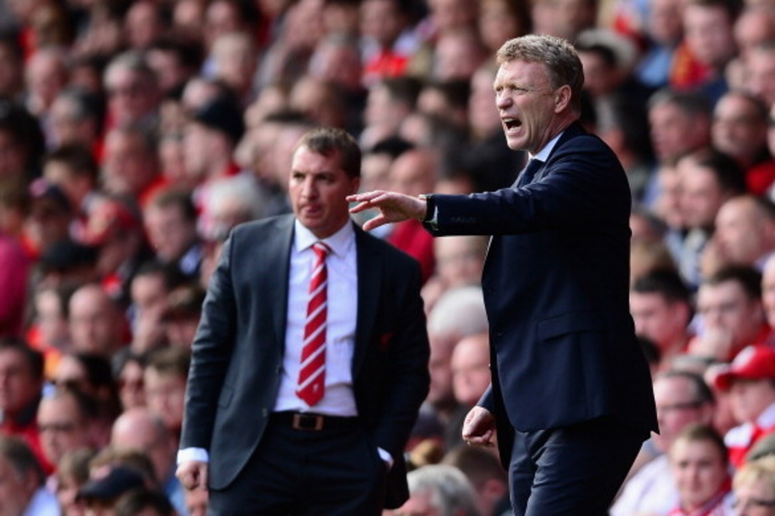 LIVERPOOL, ENGLAND - MAY 05:  Everton Manager David Moyes gestures as Liverpool Manager Brendan Rodgers looks on during the Barclays Premier League match between Liverpool and Everton at Anfield on May 5, 2013 in Liverpool, England.  (Photo by Laurence Gr